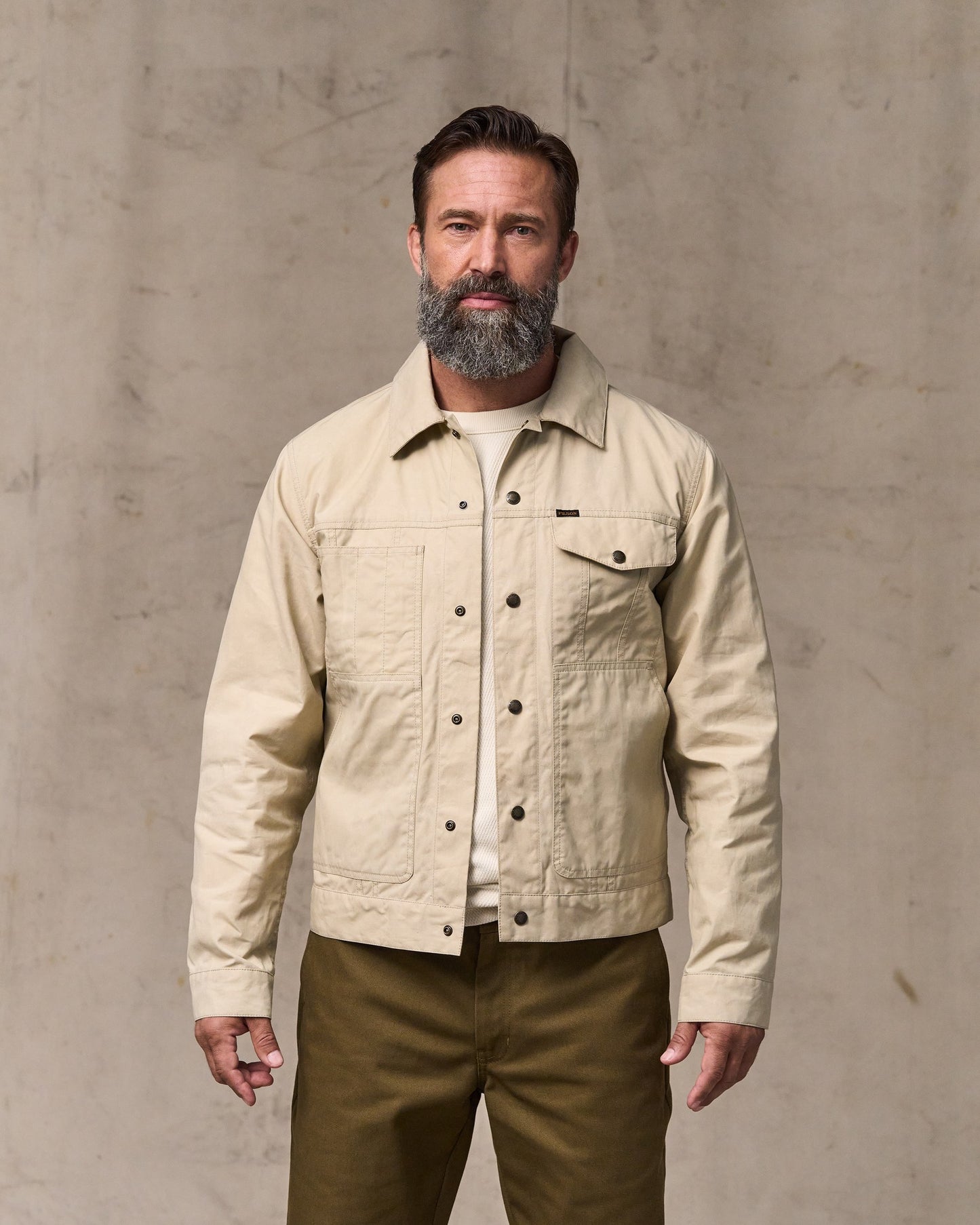 image of a model wearing Filson's Dry Wax Short Cruiser Jacket - Quail Tan|Model is 6'1" wearing a size medium