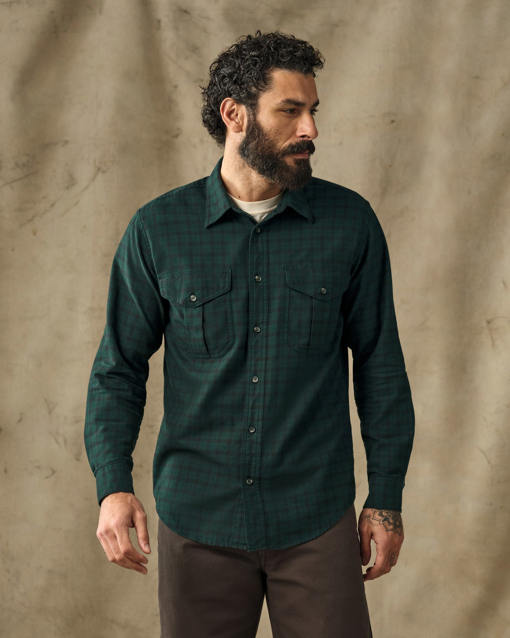image of a model wearing Filson's Lightweight Alaskan Guide Shirt - Pine / Black Plaid