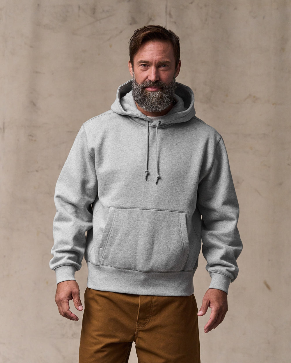 image of a model wearing Filson's 14-oz. Heritage Fleece Hoodie - Gray Heather