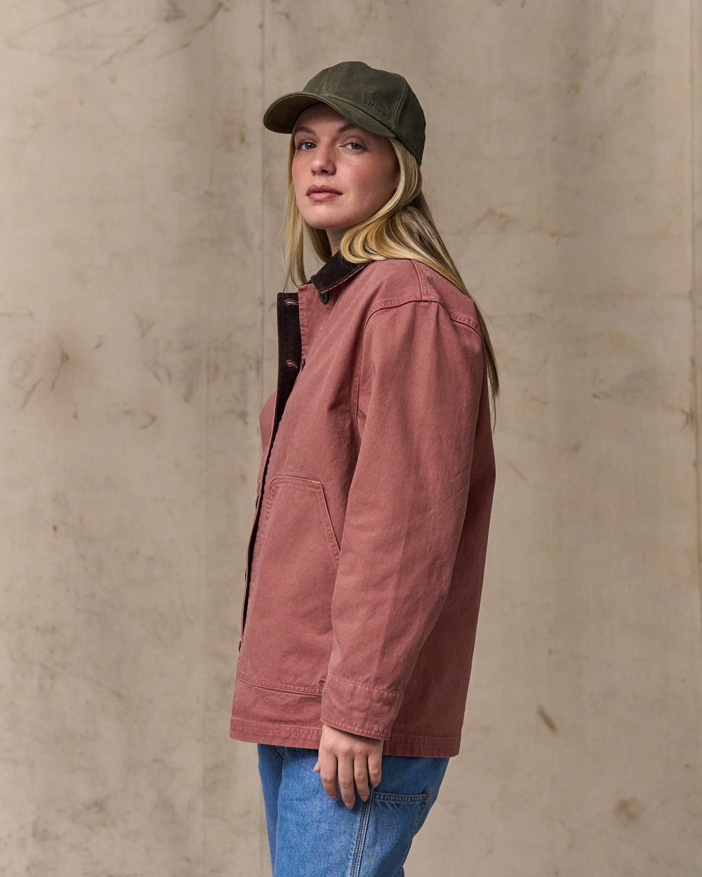 image of a model wearing Filson's Women's Canvas Barn Coat - Mahogany