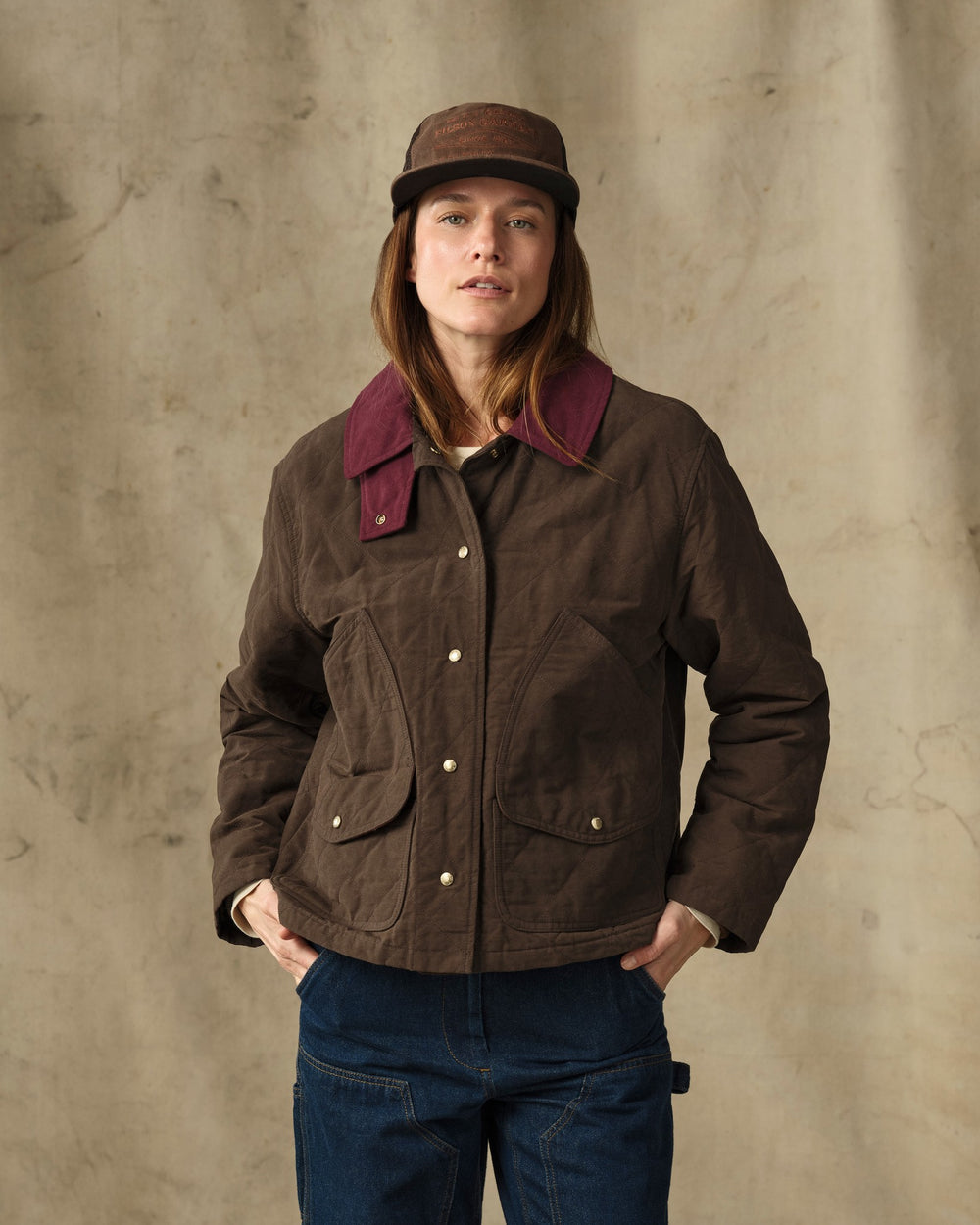 image of a model wearing Filson's Women's Quilted Outfitter Jacket - Dark Brown