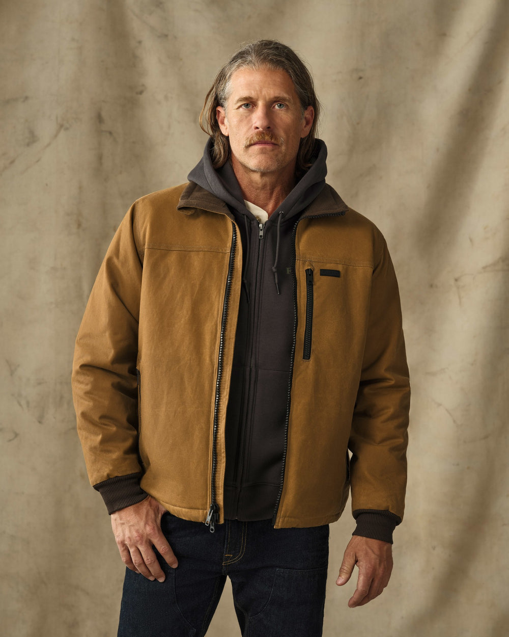 image of a model wearing Filson's Tin Cloth Insulated Jacket - Dark Tan