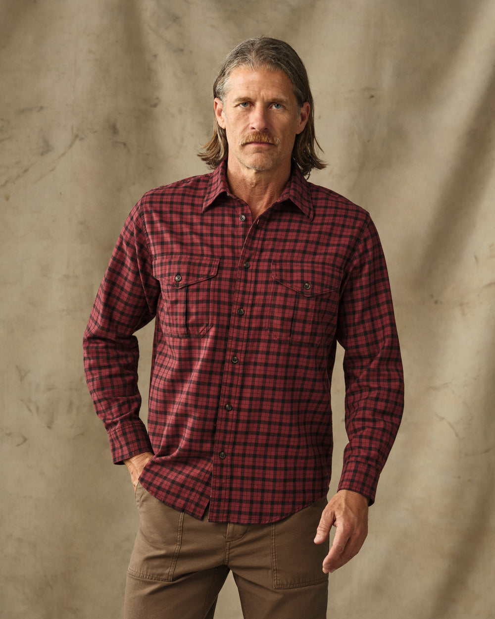 image of a model wearing Filson's Lightweight Alaskan Guide Shirt - Port / Black Plaid