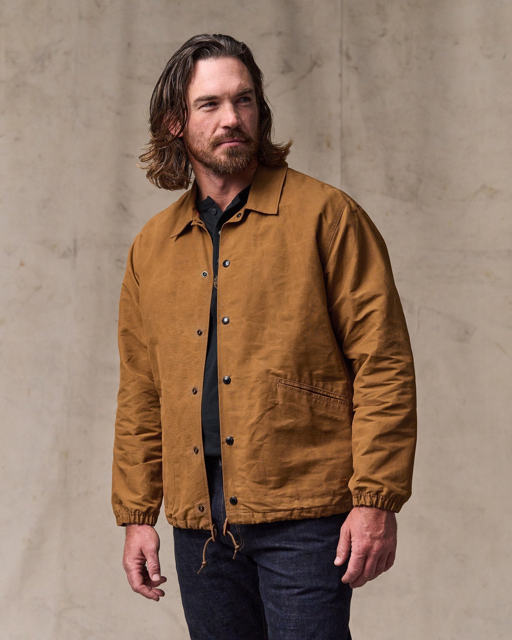 image of a model wearing Filson's Dry Wax Windbreaker - Harvest Tan