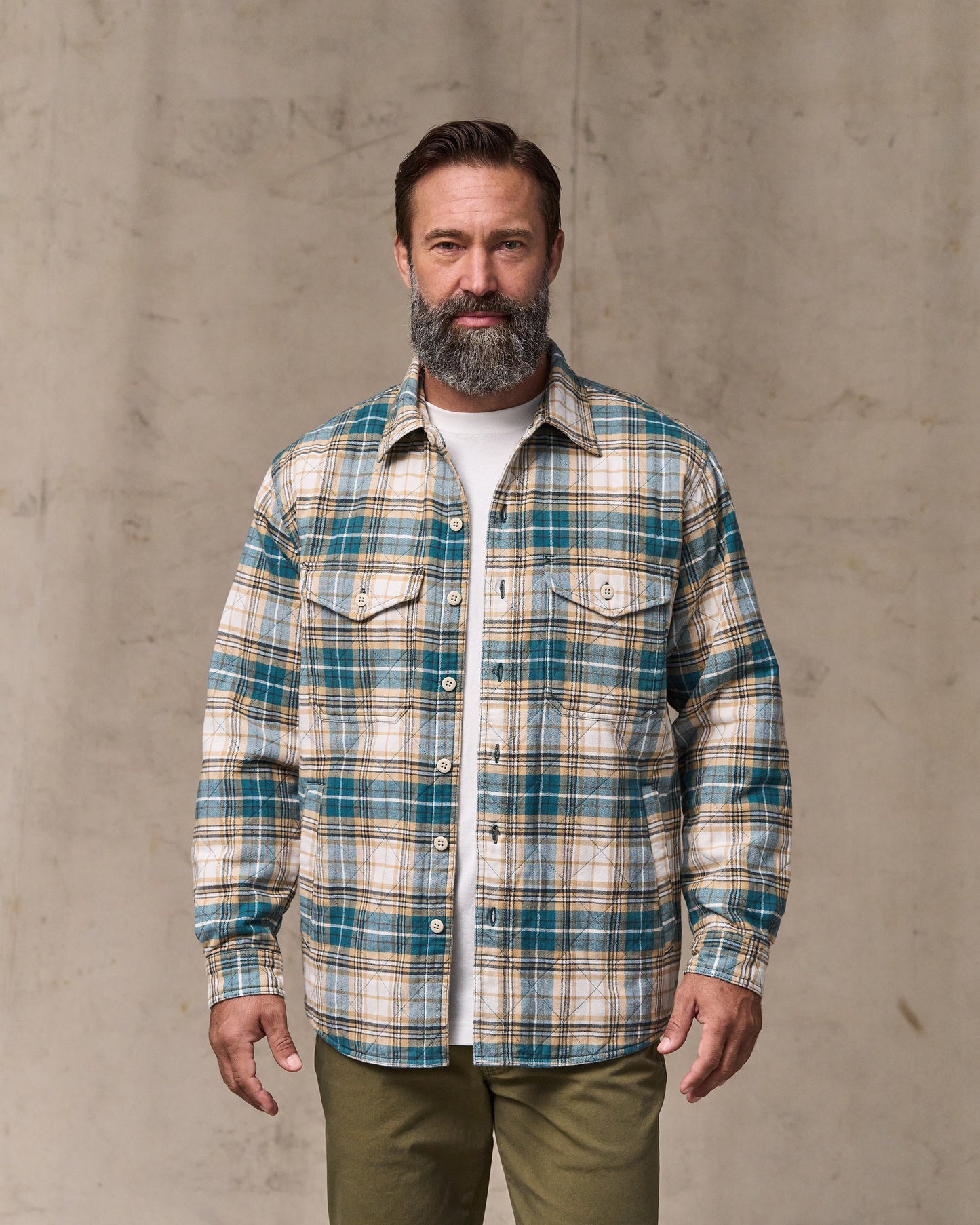 image of a model wearing Filson's Insulated Flannel Jac-shirt - Teal / Khaki Plaid|Model is 6'1" wearing a size medium