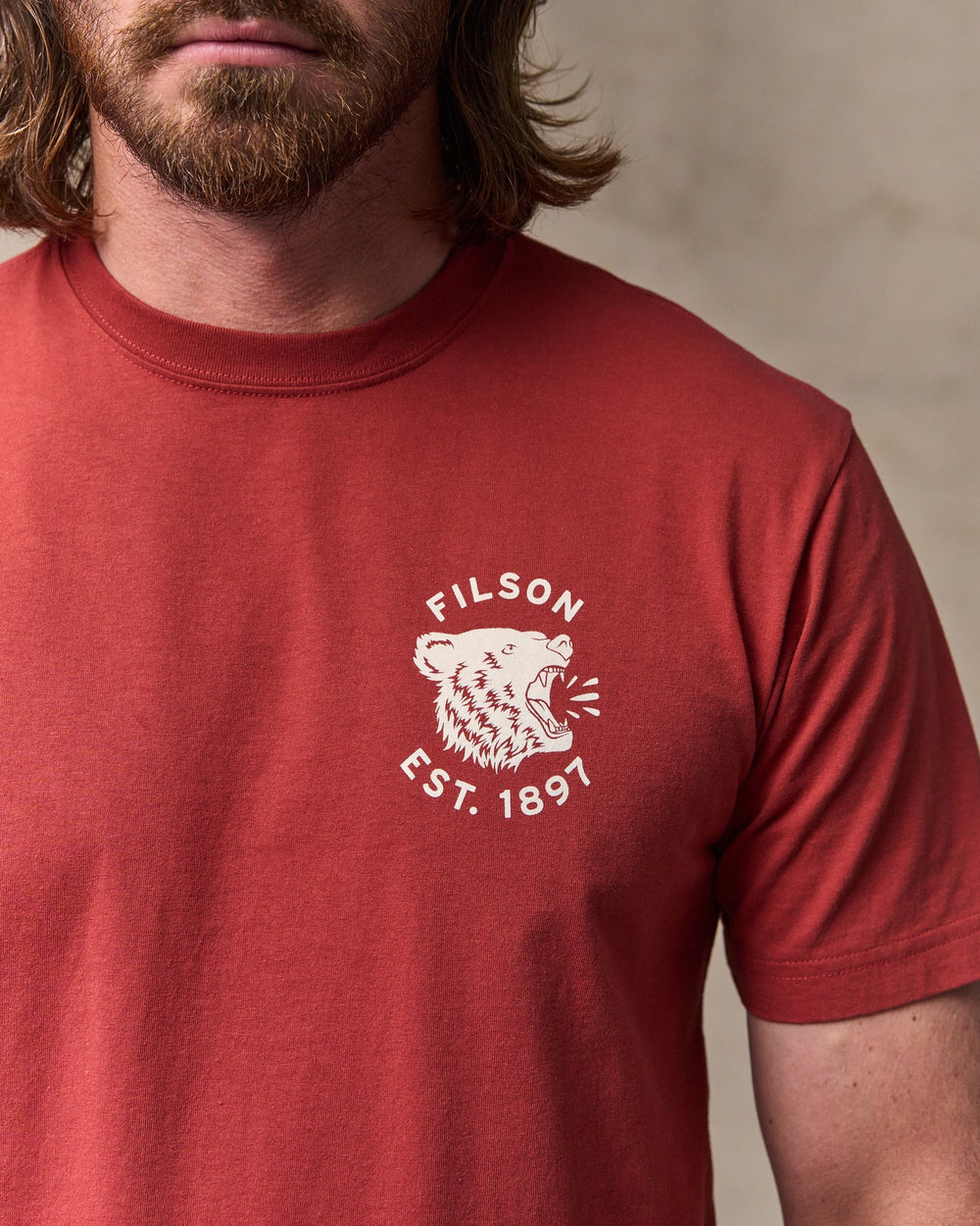 image of a model wearing Filson's Bear Graphic T-shirt - Chili Oil