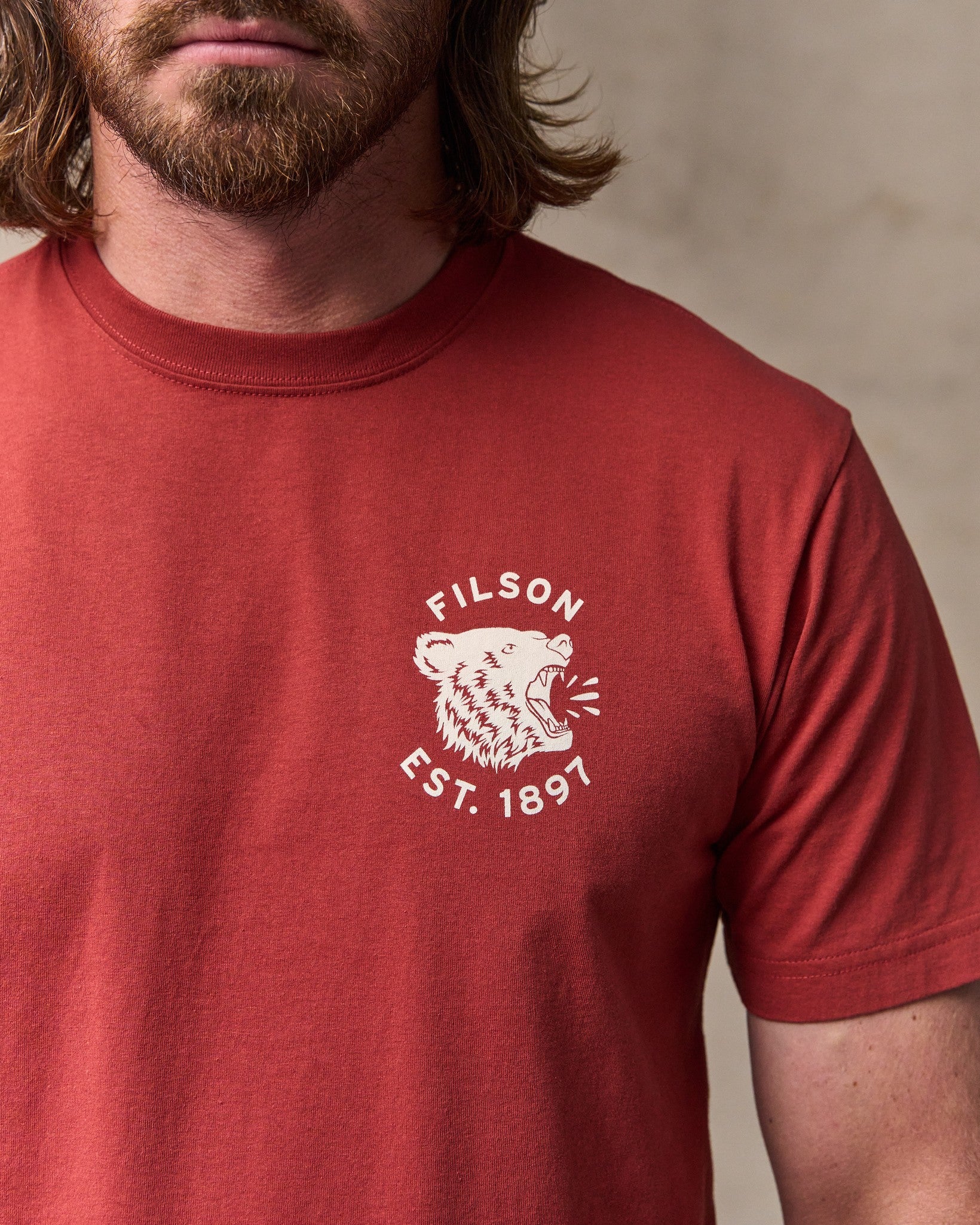 image of a model wearing Filson's Bear Graphic T-shirt - Chili Oil
