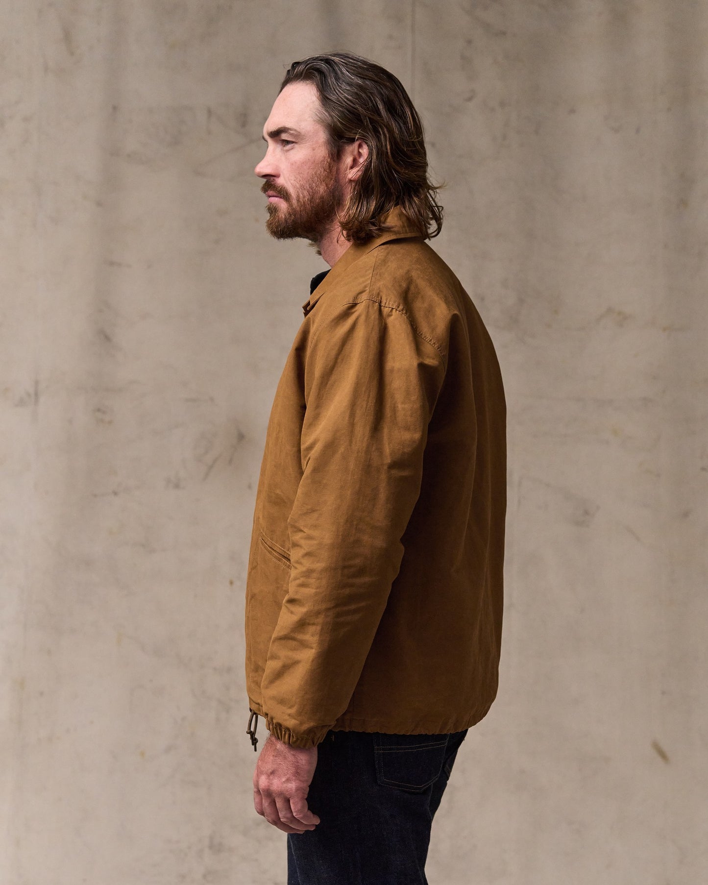 image of a model wearing Filson's Dry Wax Windbreaker - Harvest Tan