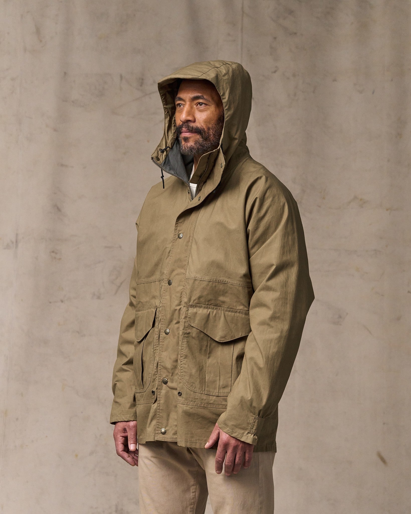 image of a model wearing Filson's Dry Wax Omak Coat - Dark Beige
