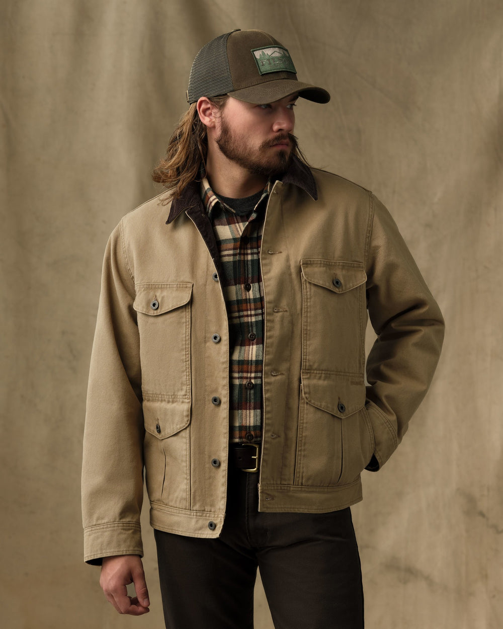image of a model wearing Filson's Rustic Canvas Journeyman Jacket - Antique Bronze