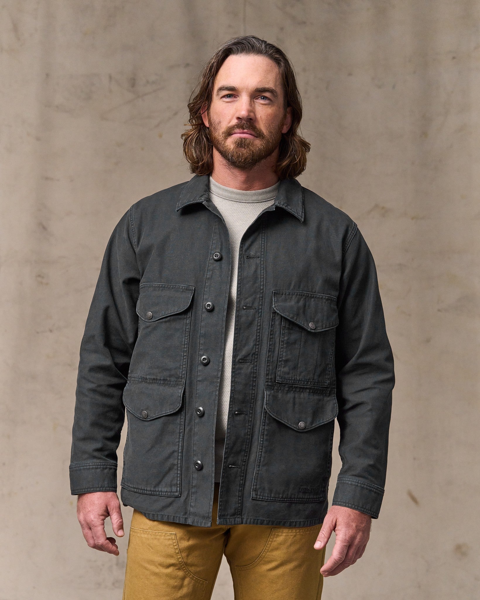 image of a model wearing Filson's Field Cruiser Jacket - Washed Faded Black