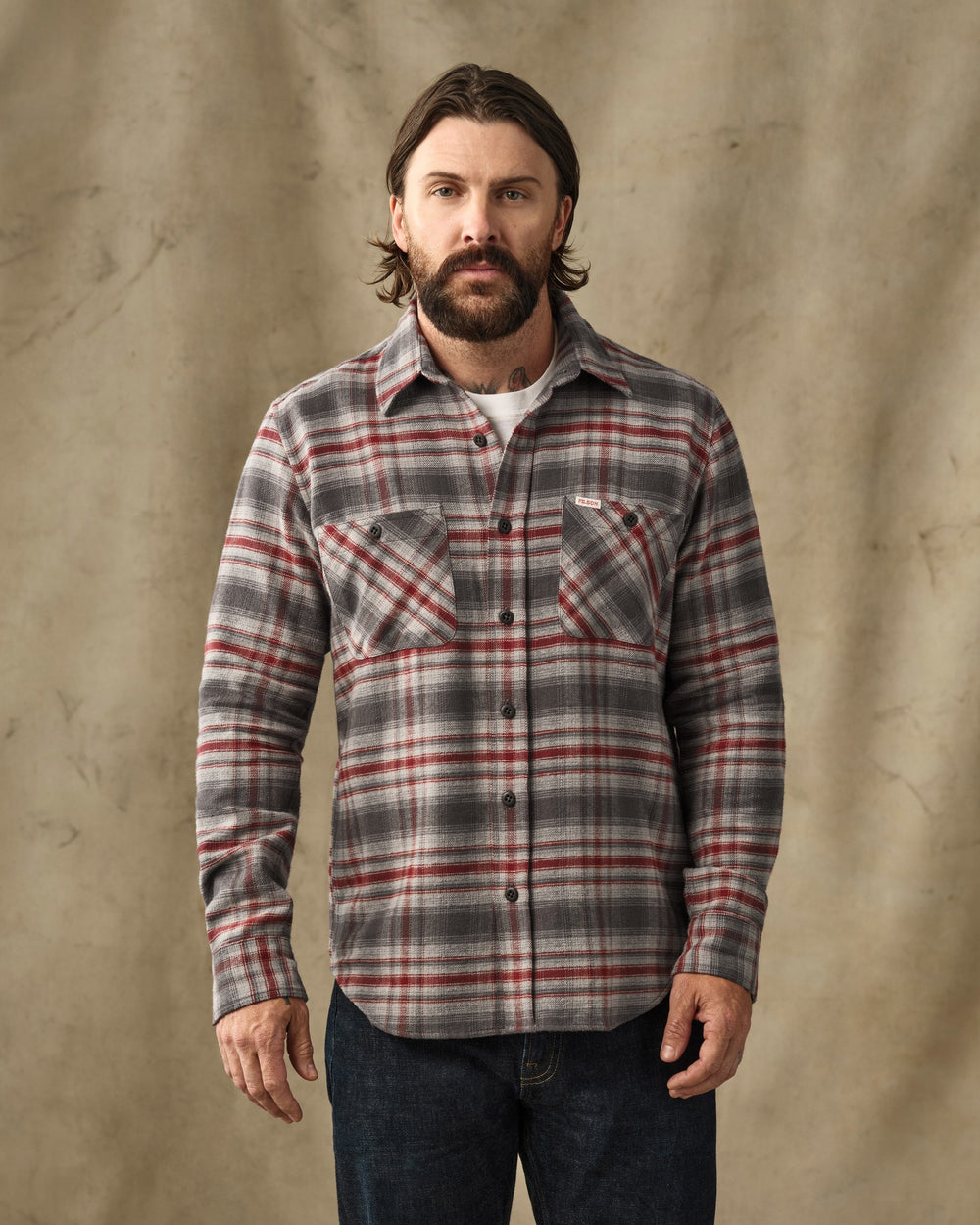 image of a model wearing Filson's Rangeland Flannel Shirt - Red / Gray Plaid