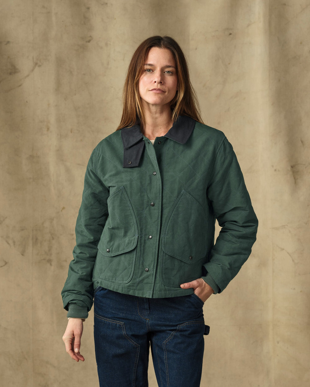 image of a model wearing Filson's Women's Quilted Outfitter Jacket - Deep Forest
