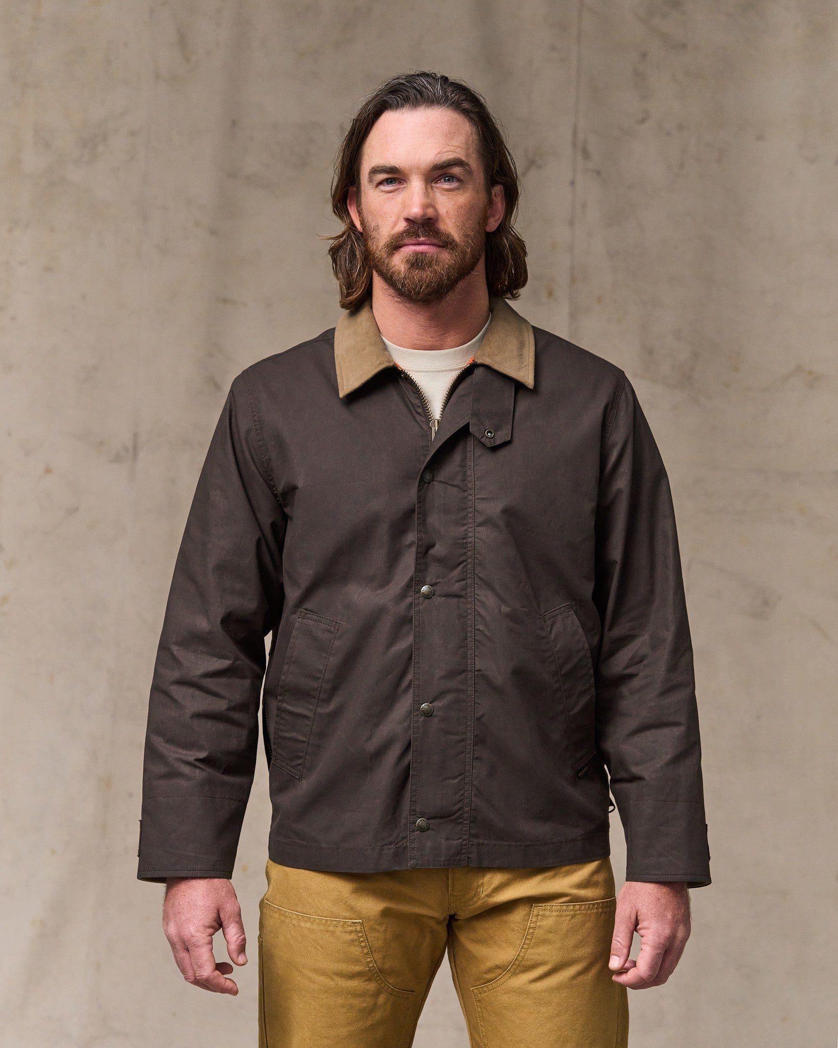 image of a model wearing Filson's Dry Wax Short Field Jacket - Dark Brown