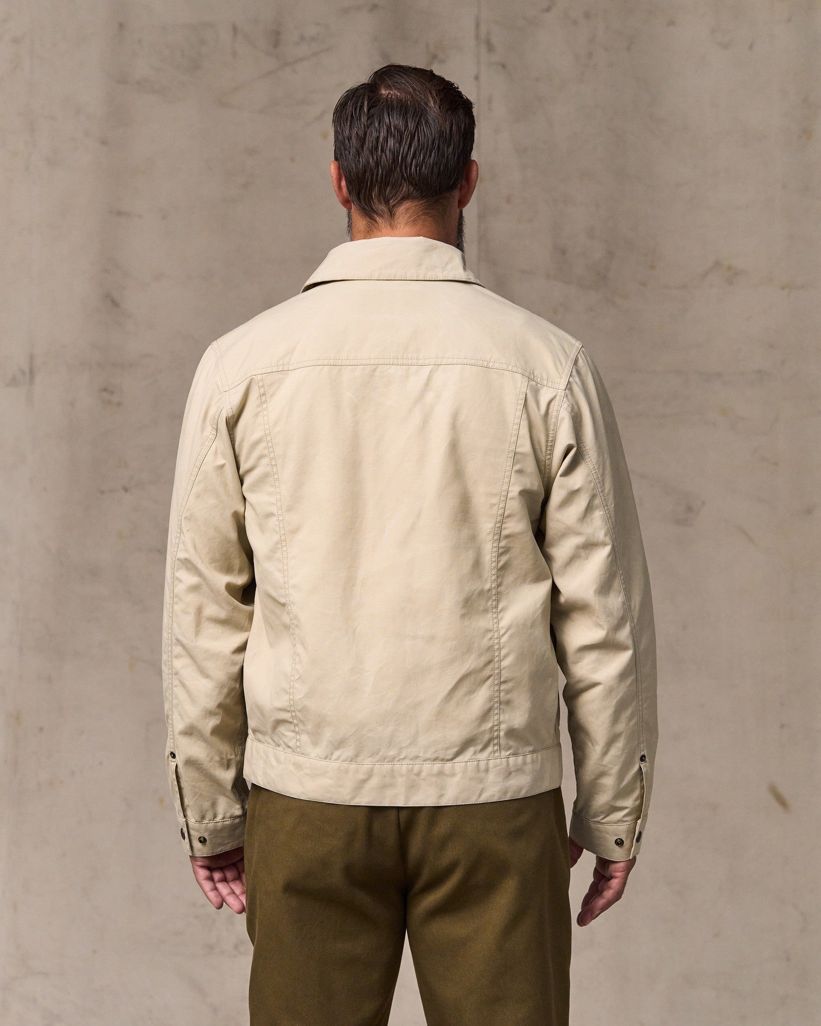 image of a model wearing Filson's Dry Wax Short Cruiser Jacket - Quail Tan