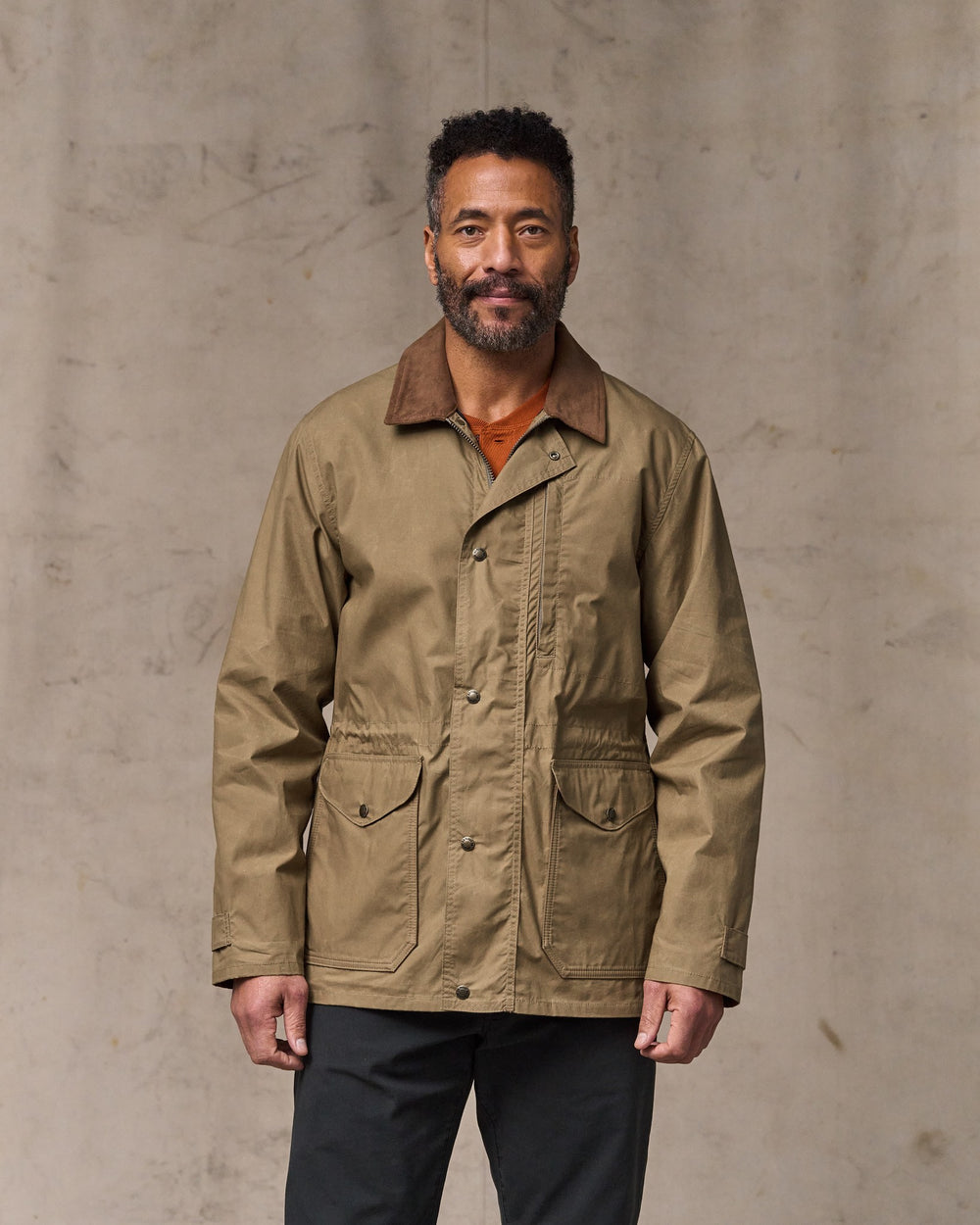 image of a model wearing Filson's Dry Wax Mile Marker Coat - Dark Beige