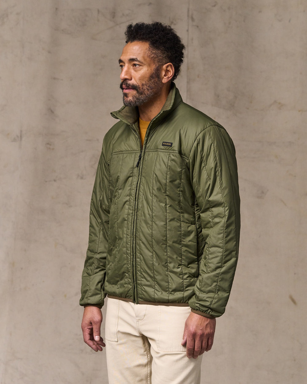 image of a model wearing Filson's Ultralight Jacket - Dark Olive Drab