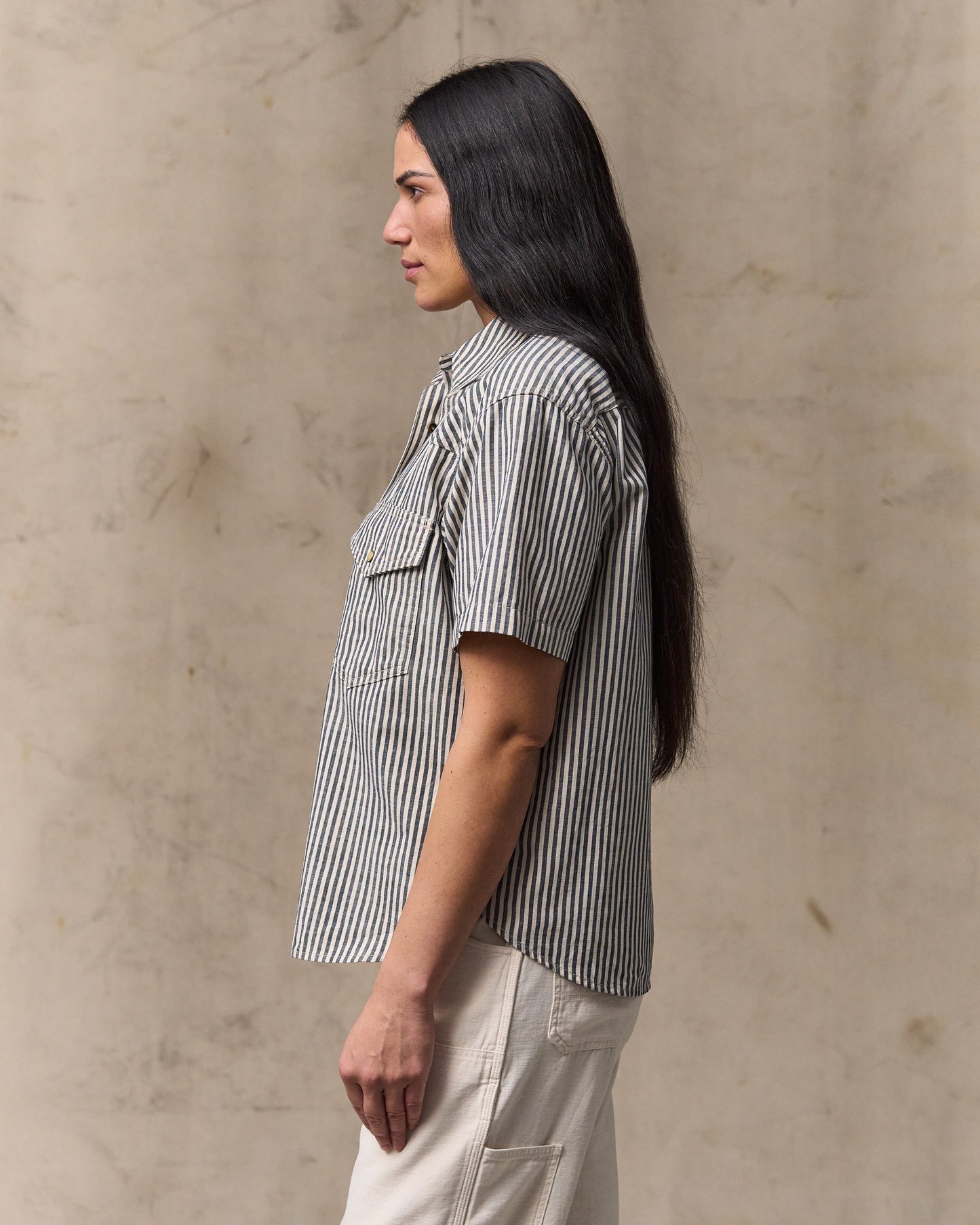 image of a model wearing Filson's Women's Short Sleeve Chambray Western Shirt - Indigo / Natural