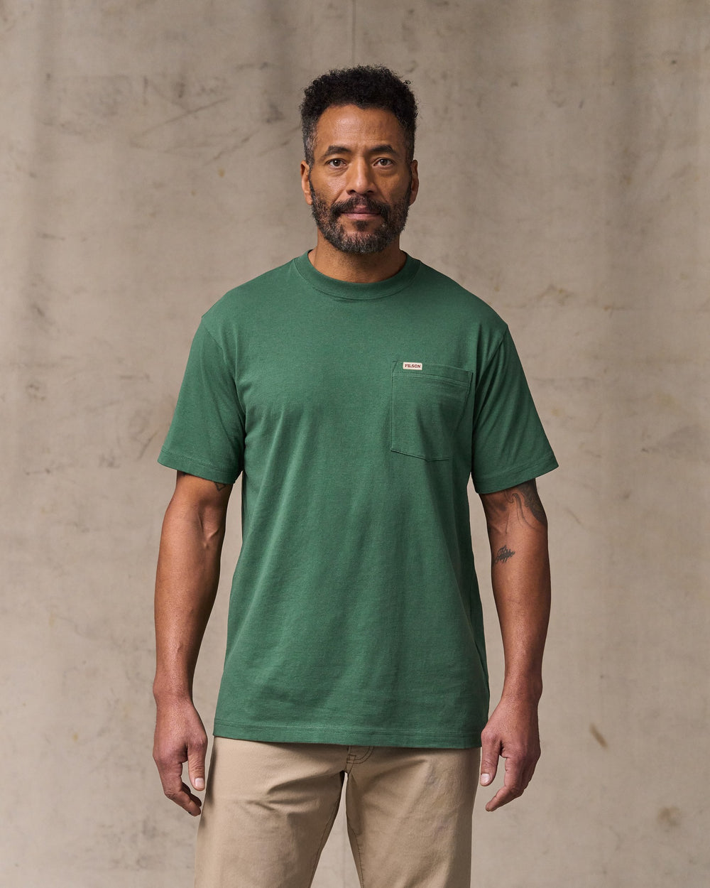 image of a model wearing Filson's Outfitter Pocket T-shirt - Olive Green