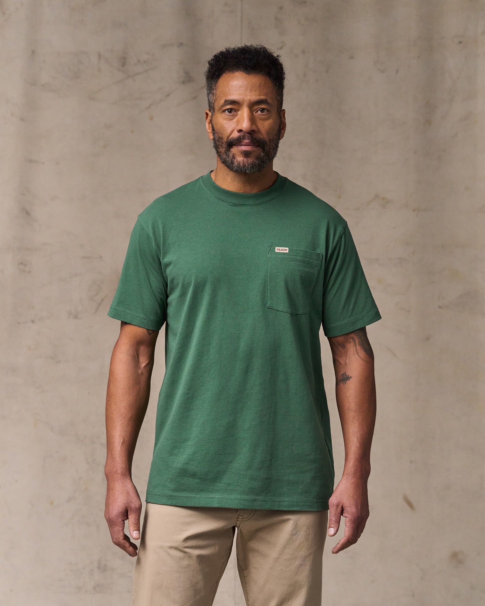 image of a model wearing Filson's Outfitter Pocket T-shirt - Olive Green