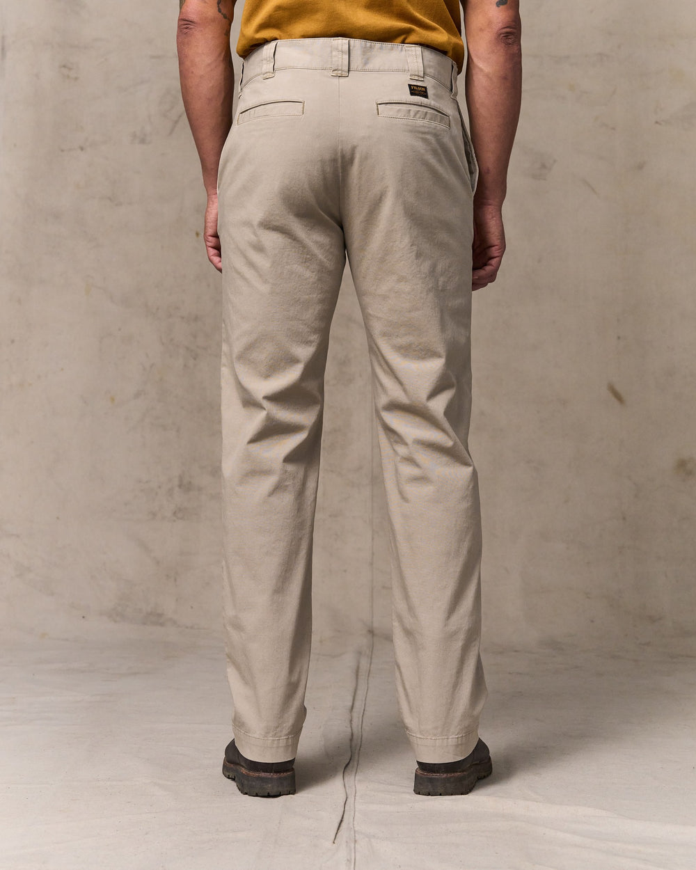 image of a model wearing Filson's Granite Mountain Flat Front Pants - Buck Tan