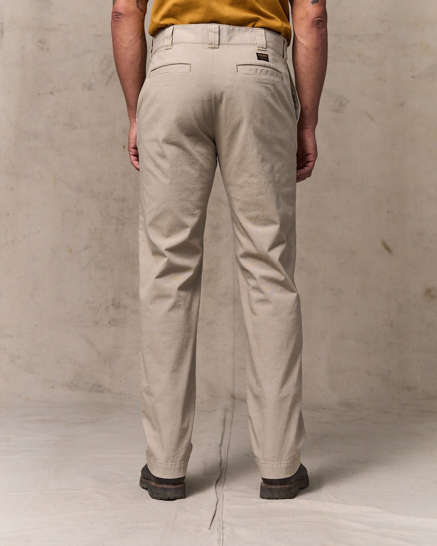 image of a model wearing Filson's Granite Mountain Flat Front Pants - Buck Tan
