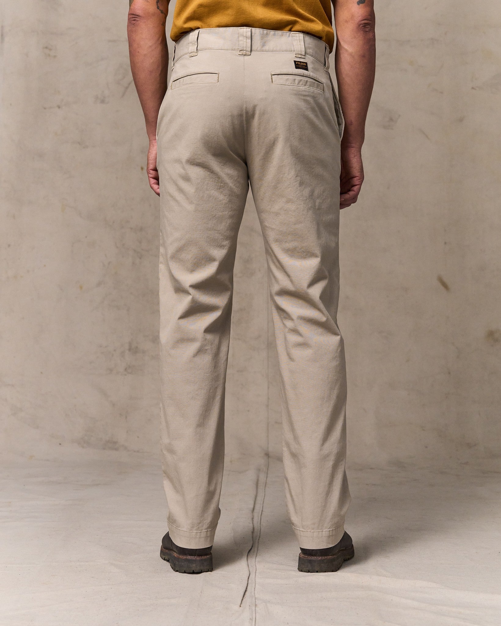 image of a model wearing Filson's Granite Mountain Flat Front Pants - Buck Tan