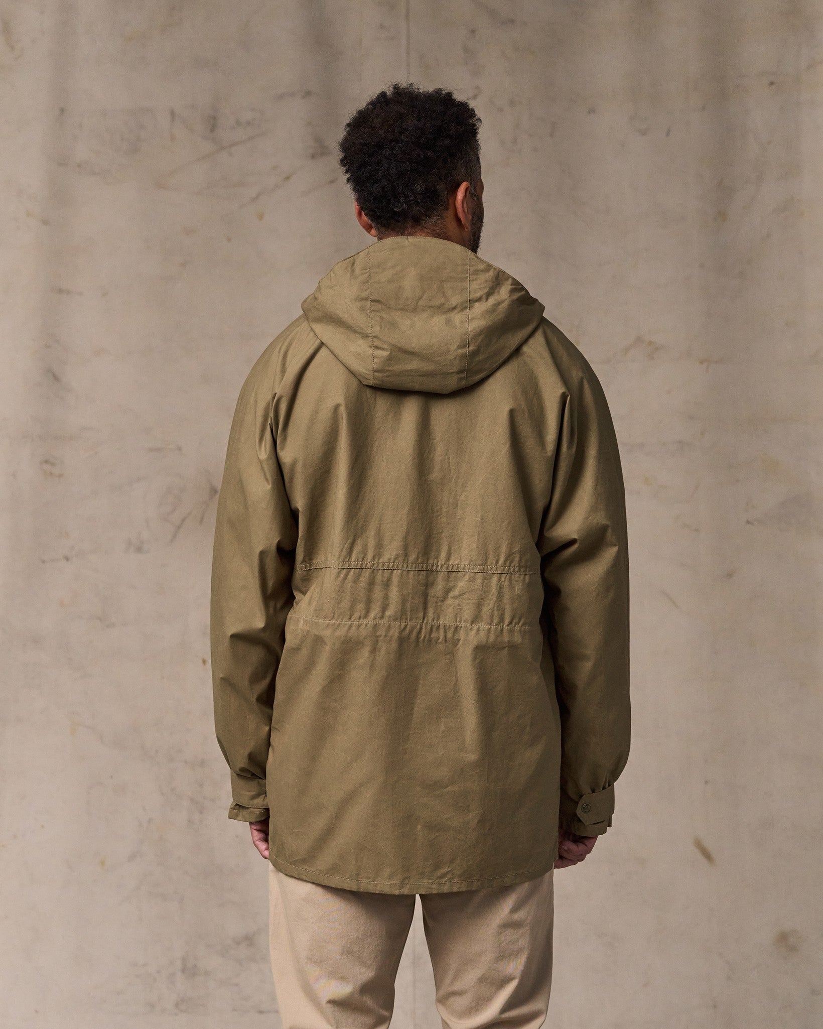 image of a model wearing Filson's Dry Wax Omak Coat - Dark Beige