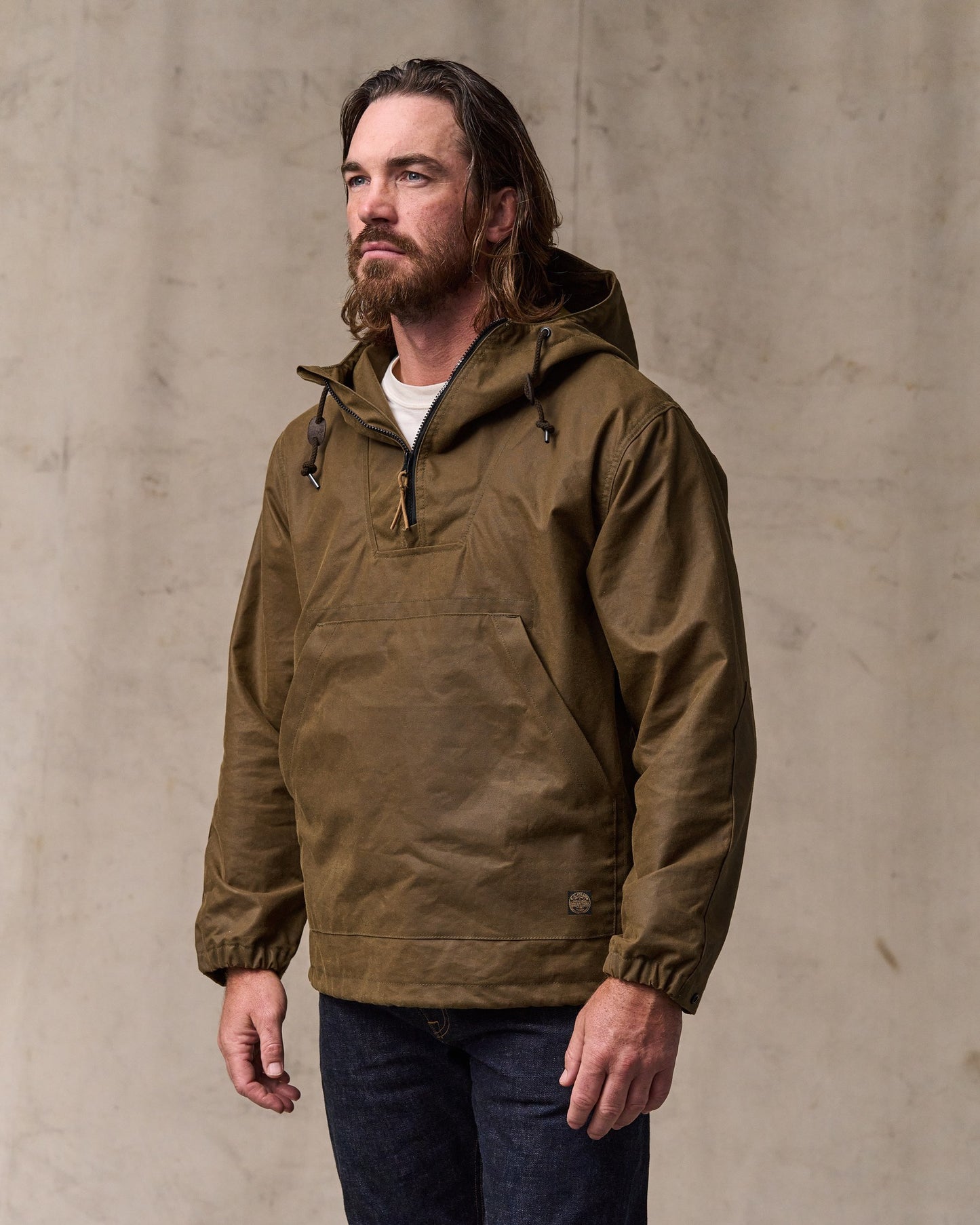 image of a model wearing Filson's Shelter Cloth Waxed Anorak - Dark Tan
