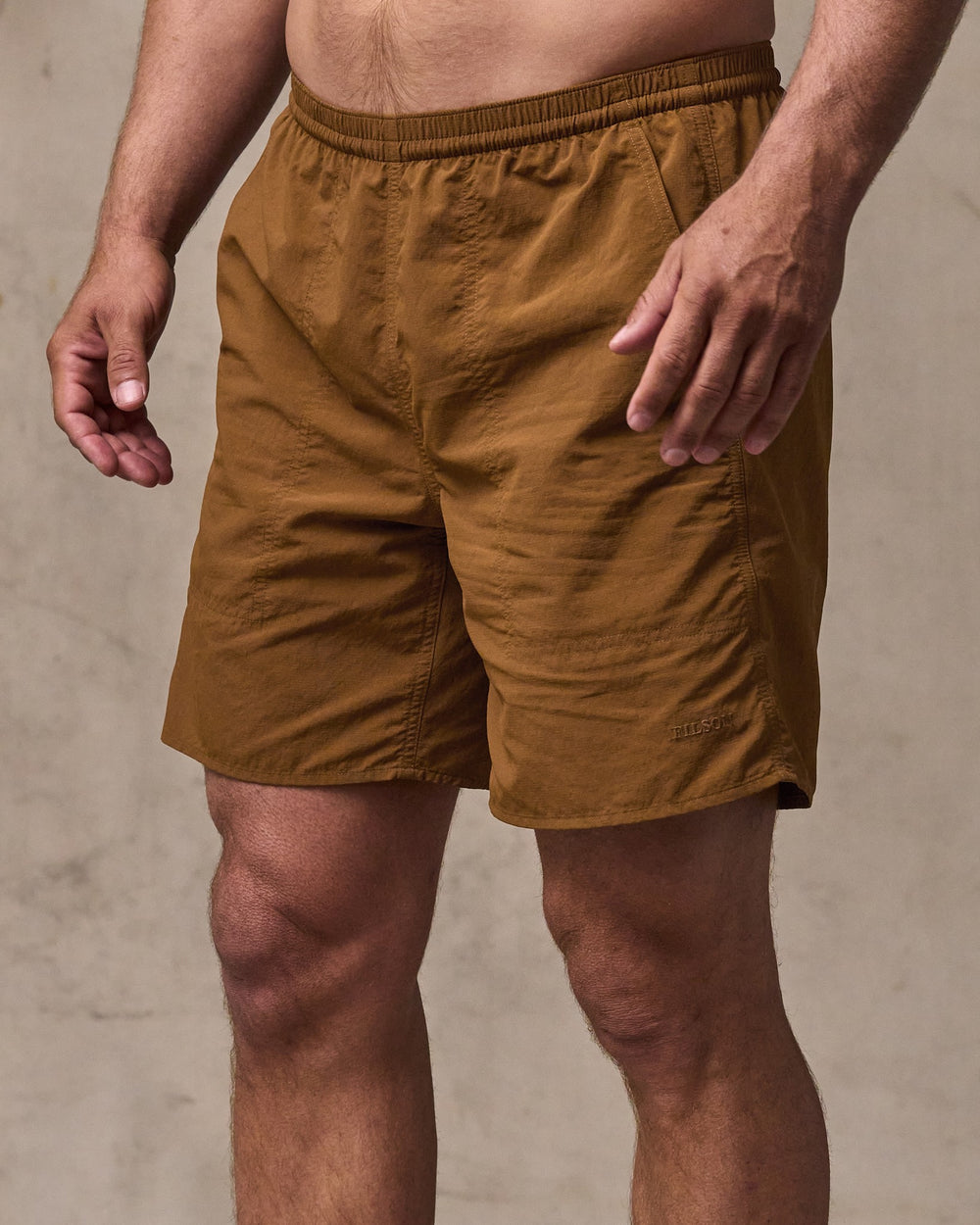 image of a model wearing Filson's Oxbow Lake Trunks - Whiskey
