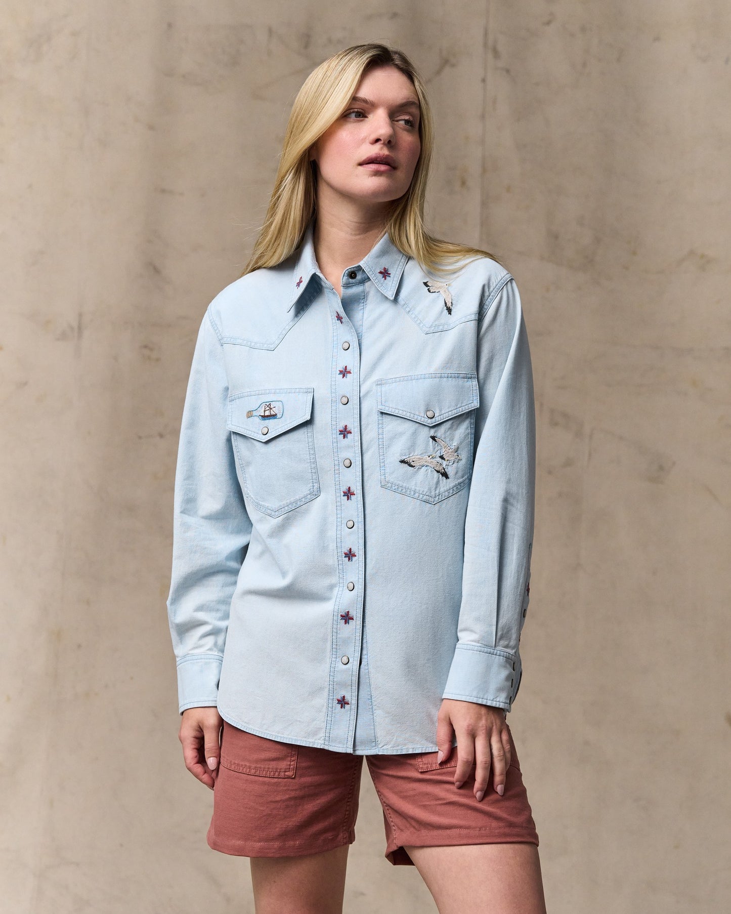 image of a model wearing Filson's Women's Embroidered Western Shirt - Light Indigo|Model is 5'10" wearing a size medium|Model is 5'10" wearing a size medium