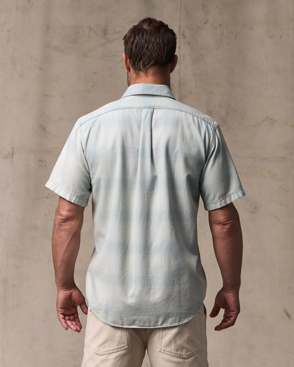 image of a model wearing Filson's Short Sleeve Lightweight Alaskan Guide Shirt  - Indigo Plaid
