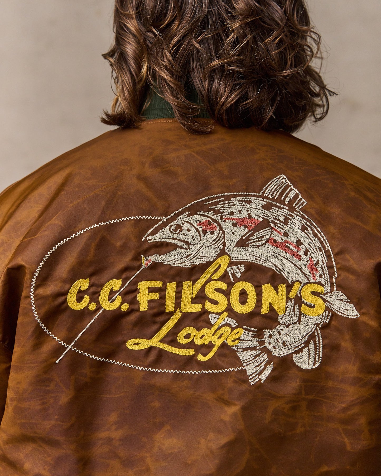 image of a model wearing Filson's Embroidered Montlake Jacket - Whiskey