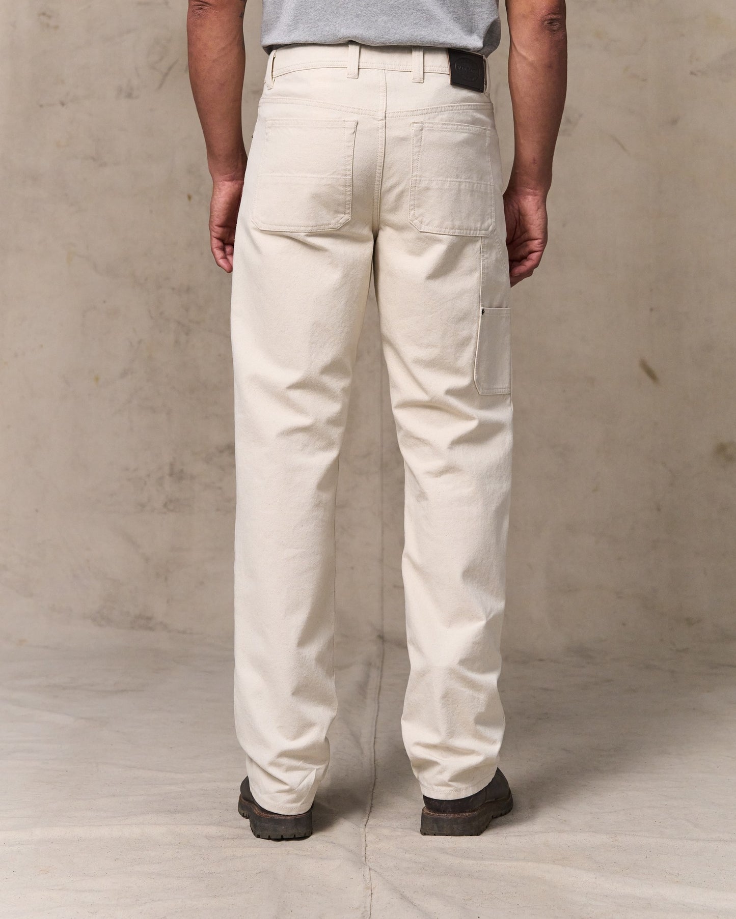 image of a model wearing Filson's Dry Tin Double Front Pants - Natural Seed