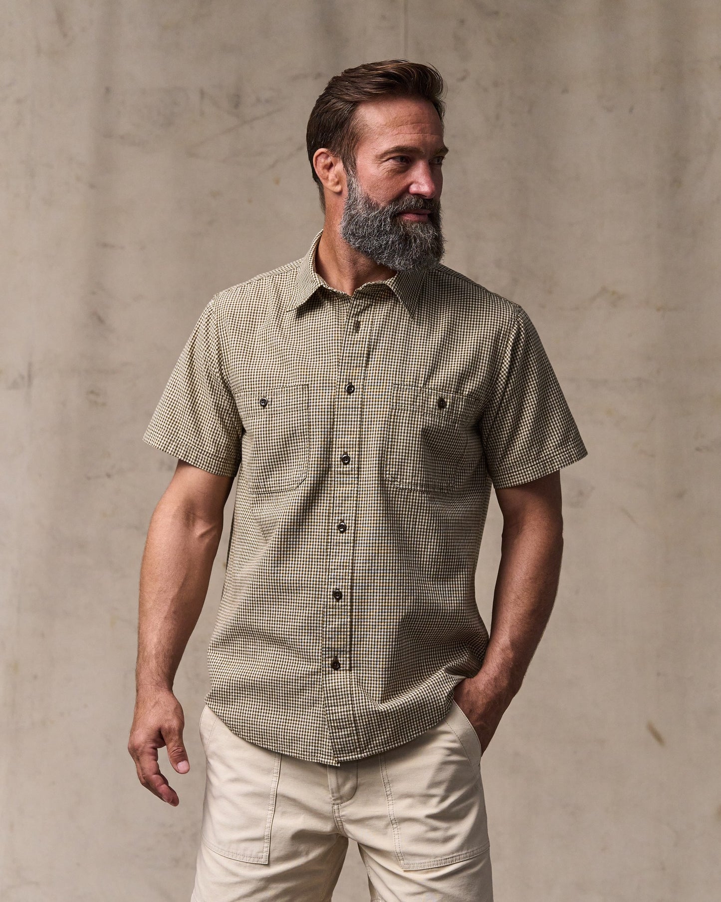 image of a model wearing Filson's Short Sleeve Chambray Shirt  - Coffee / Natural|Model is 6'1" wearing a size medium