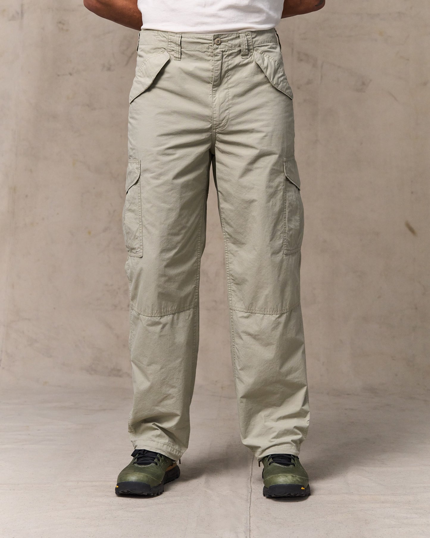image of a model wearing Filson's Tropical Poplin Cargo Pants - Dried Sage|Model is 6'2" wearing a size 34x32