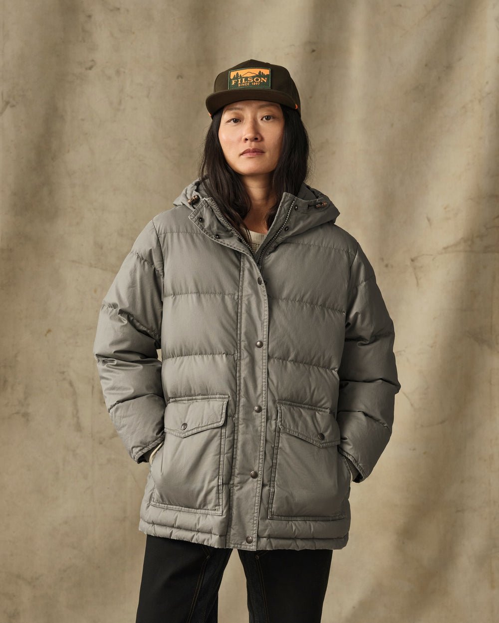 image of a model wearing Filson's Women's Heritage Cotton Down Parka - Smokey Olive