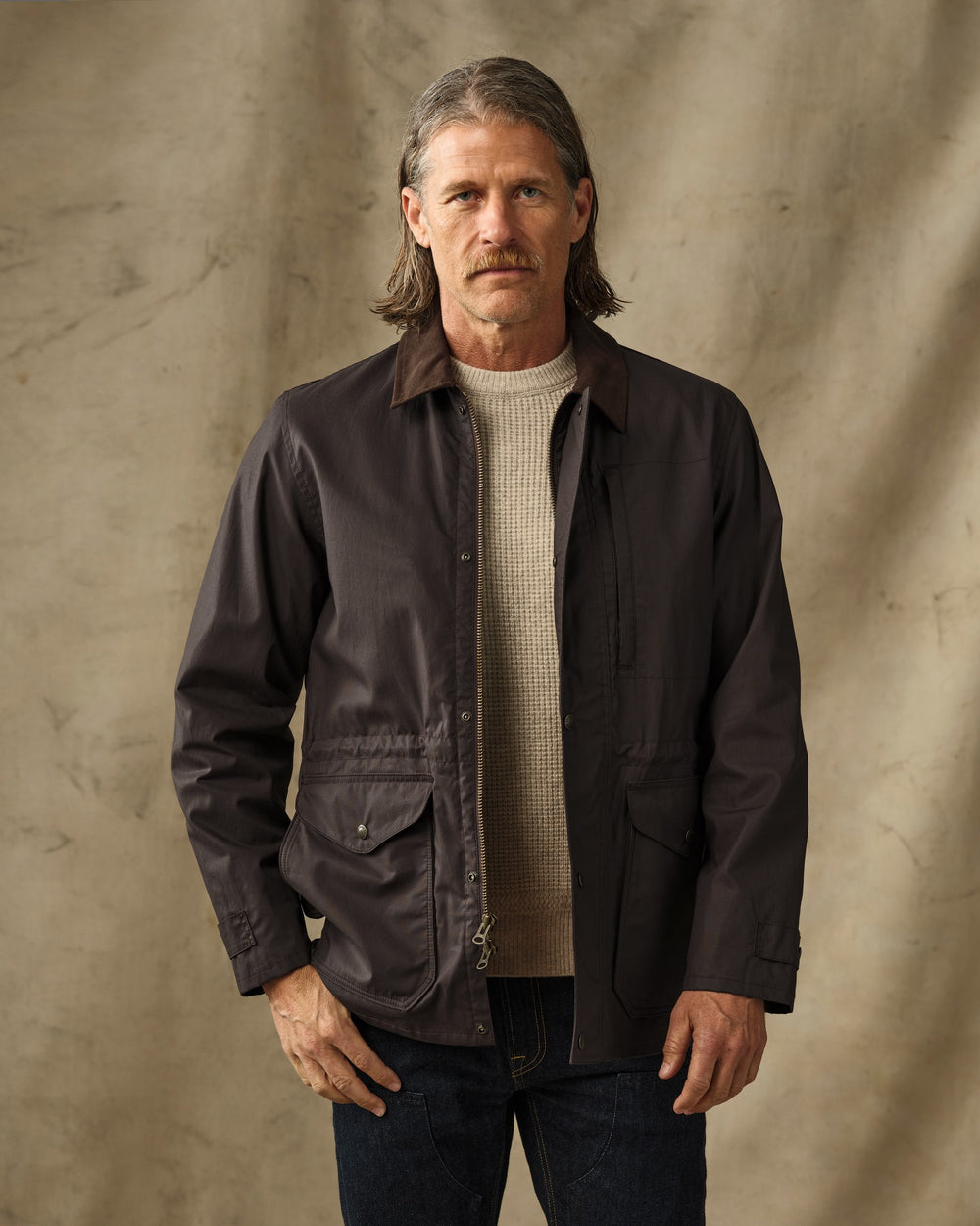 image of a model wearing Filson's Dry Wax Mile Marker Coat - Dark Brown