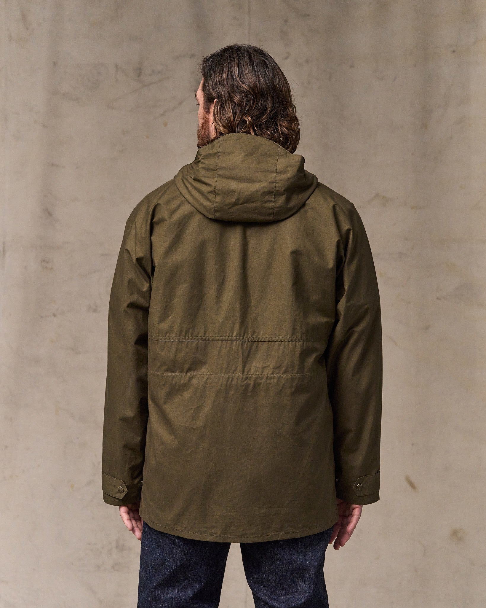 image of a model wearing Filson's Dry Wax Omak Coat - Burnt Olive