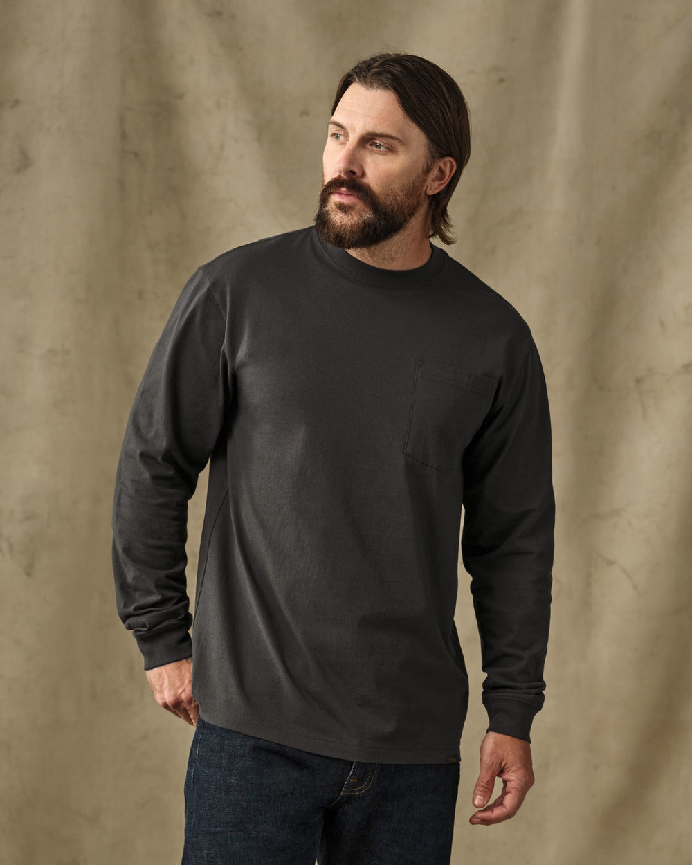 image of a model wearing Filson's Long Sleeve Outfitter Pocket T-Shirt - Faded Black