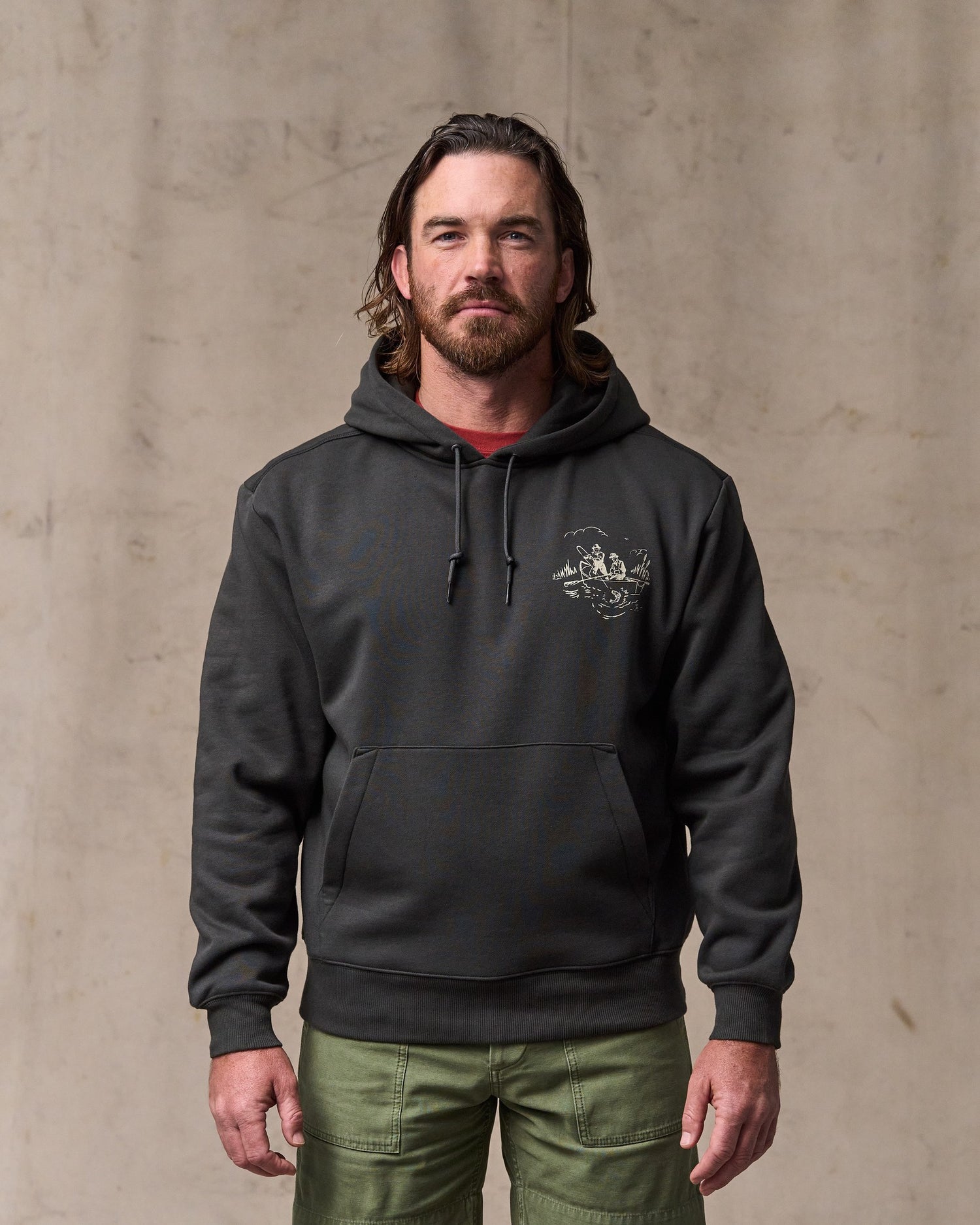 image of a model wearing Filson's Trout Graphic Hoodie - Faded Black|Model is 6'1" wearing a size medium