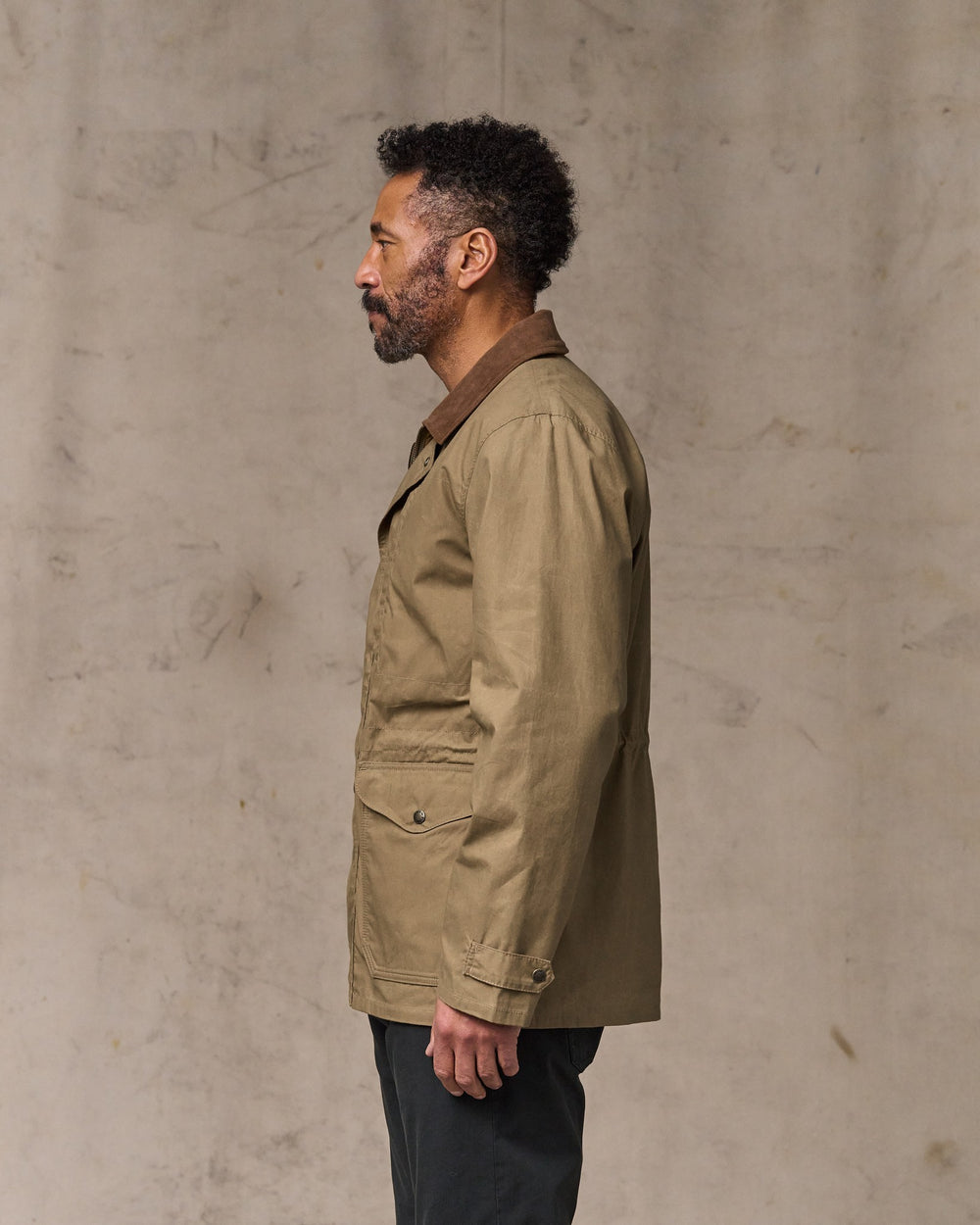 image of a model wearing Filson's Dry Wax Mile Marker Coat - Dark Beige
