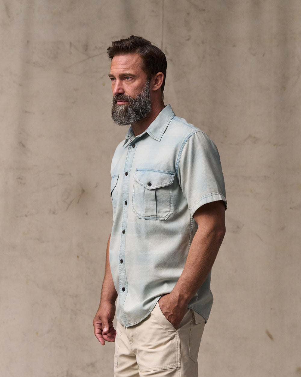 image of a model wearing Filson's Short Sleeve Lightweight Alaskan Guide Shirt  - Indigo Plaid