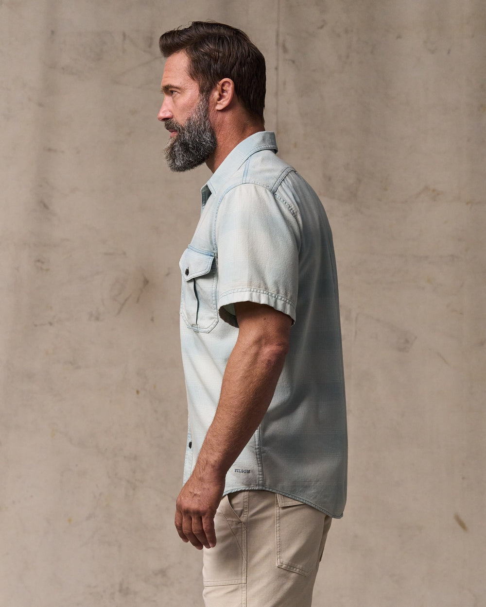 image of a model wearing Filson's Short Sleeve Lightweight Alaskan Guide Shirt  - Indigo Plaid