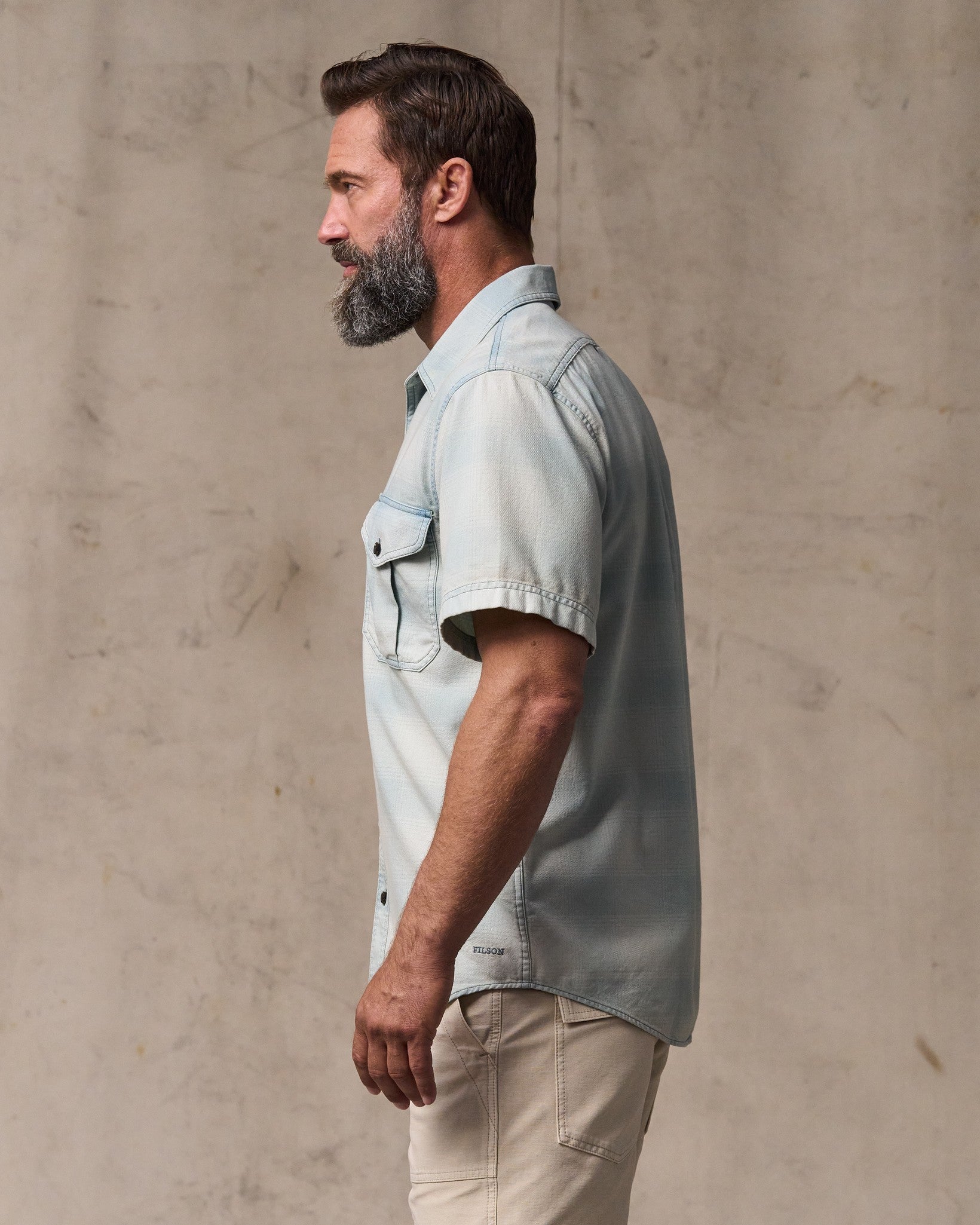 image of a model wearing Filson's Short Sleeve Lightweight Alaskan Guide Shirt  - Indigo Plaid