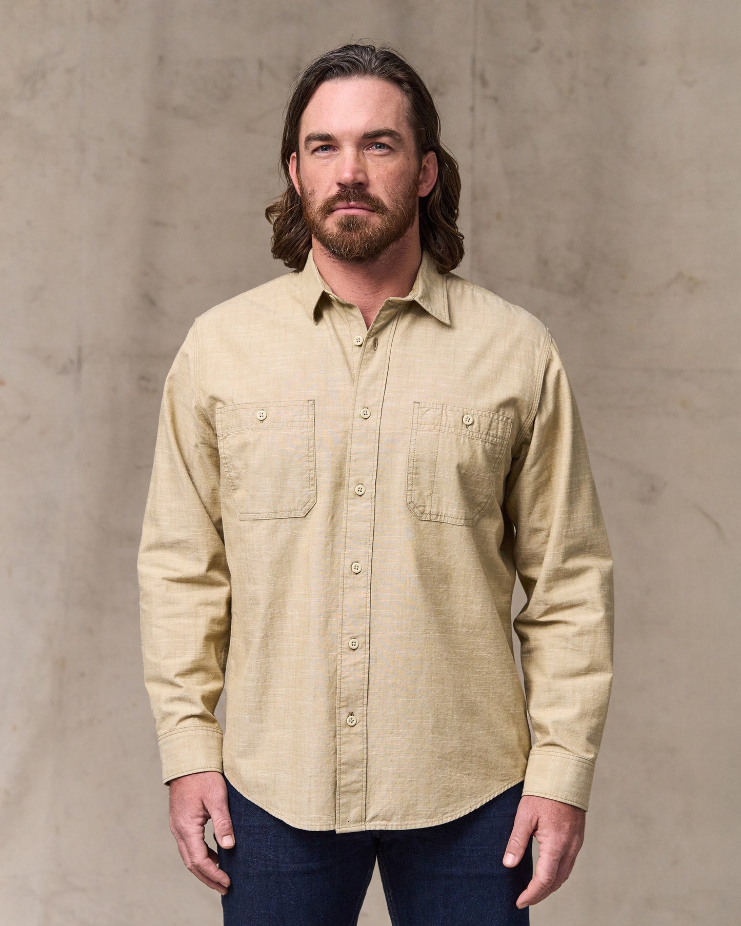 image of a model wearing Filson's Chambray Cpo Shirt - Tan|Model is 6'1" wearing a size medium