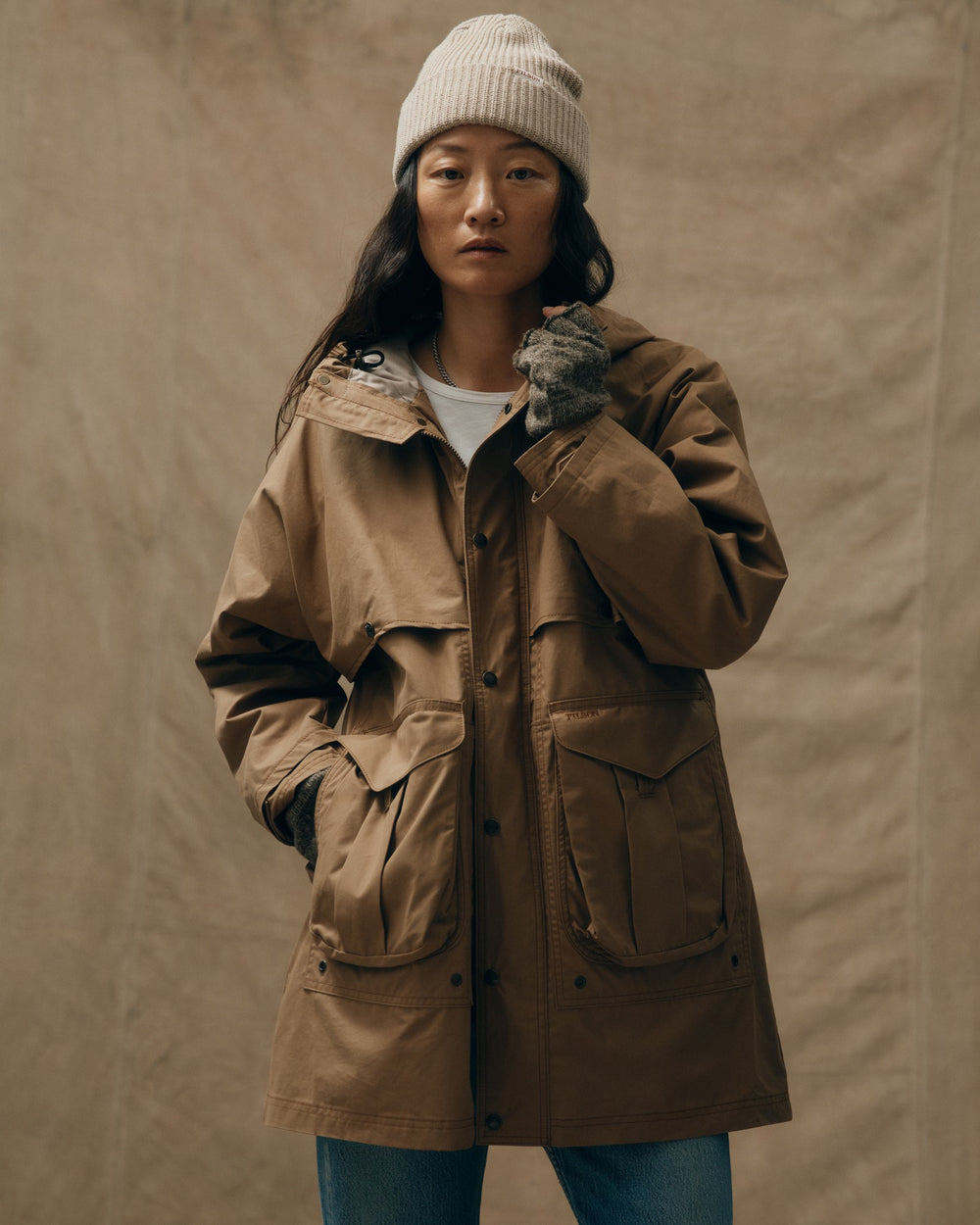 image of a model wearing Filson's Women's Aviator Cloth Long Raincoat - Dark Tan