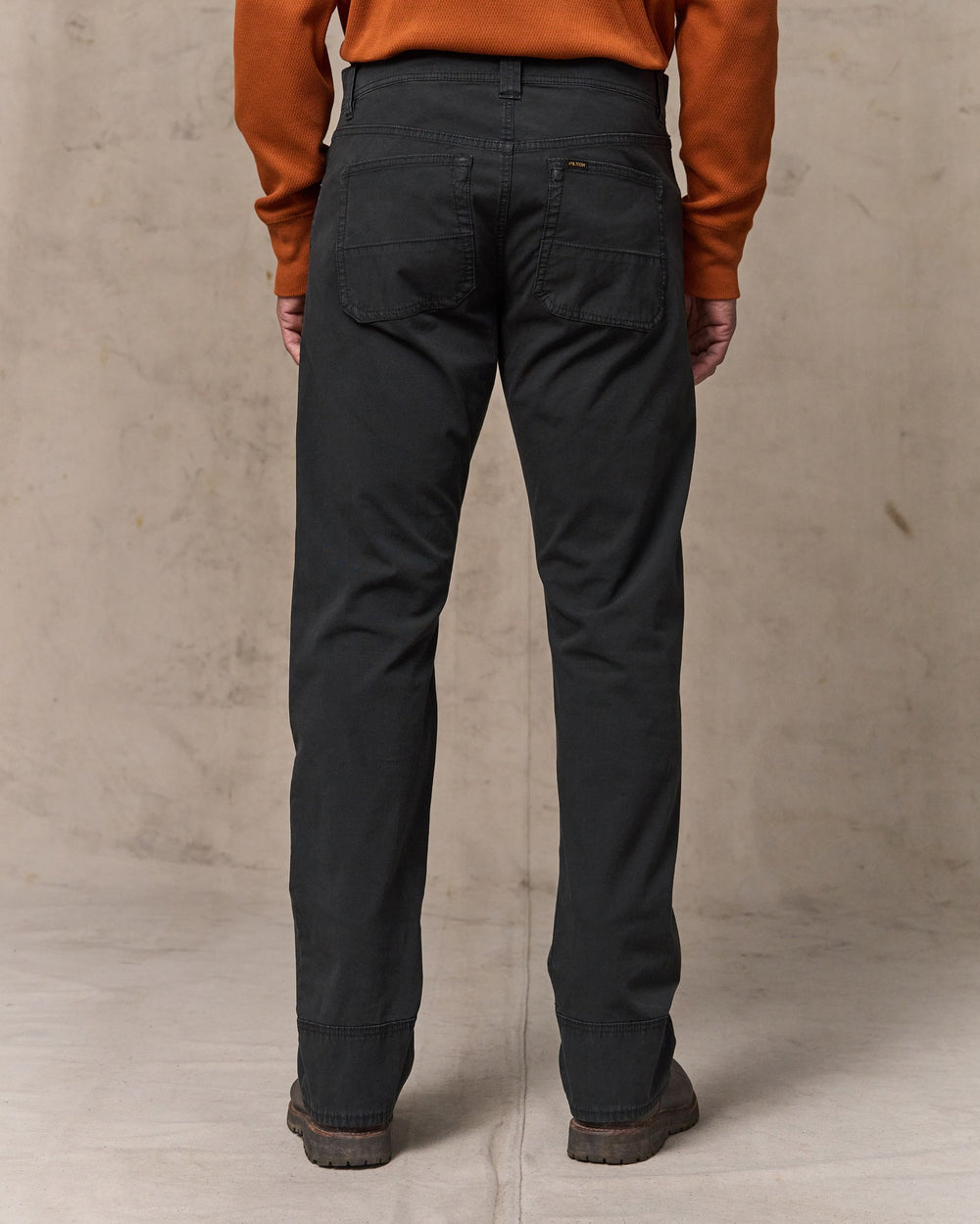 image of a model wearing Filson's Granite Mountain 5-pocket Pants - Washed Faded Black