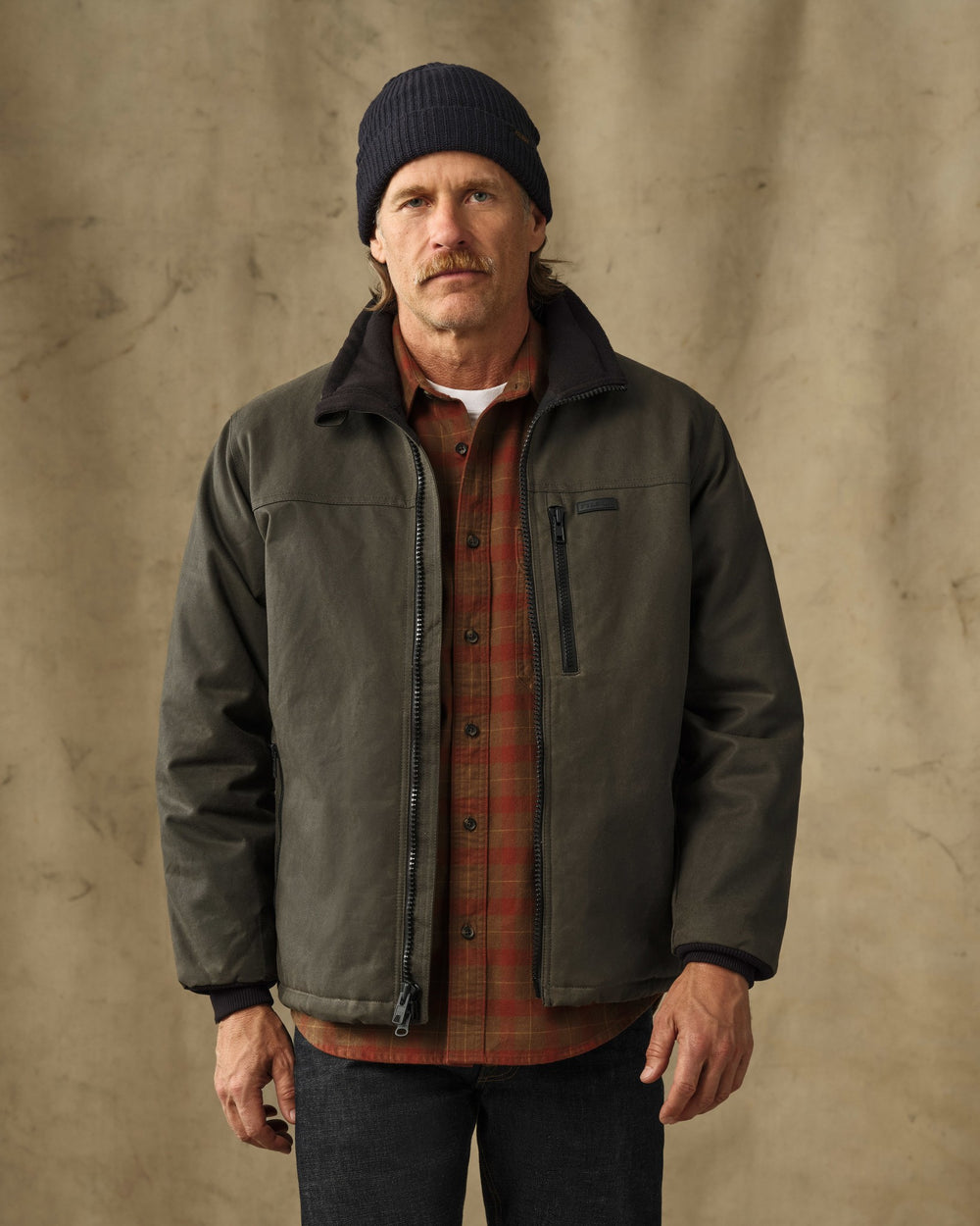 image of a model wearing Filson's Tin Cloth Insulated Jacket - Otter Green