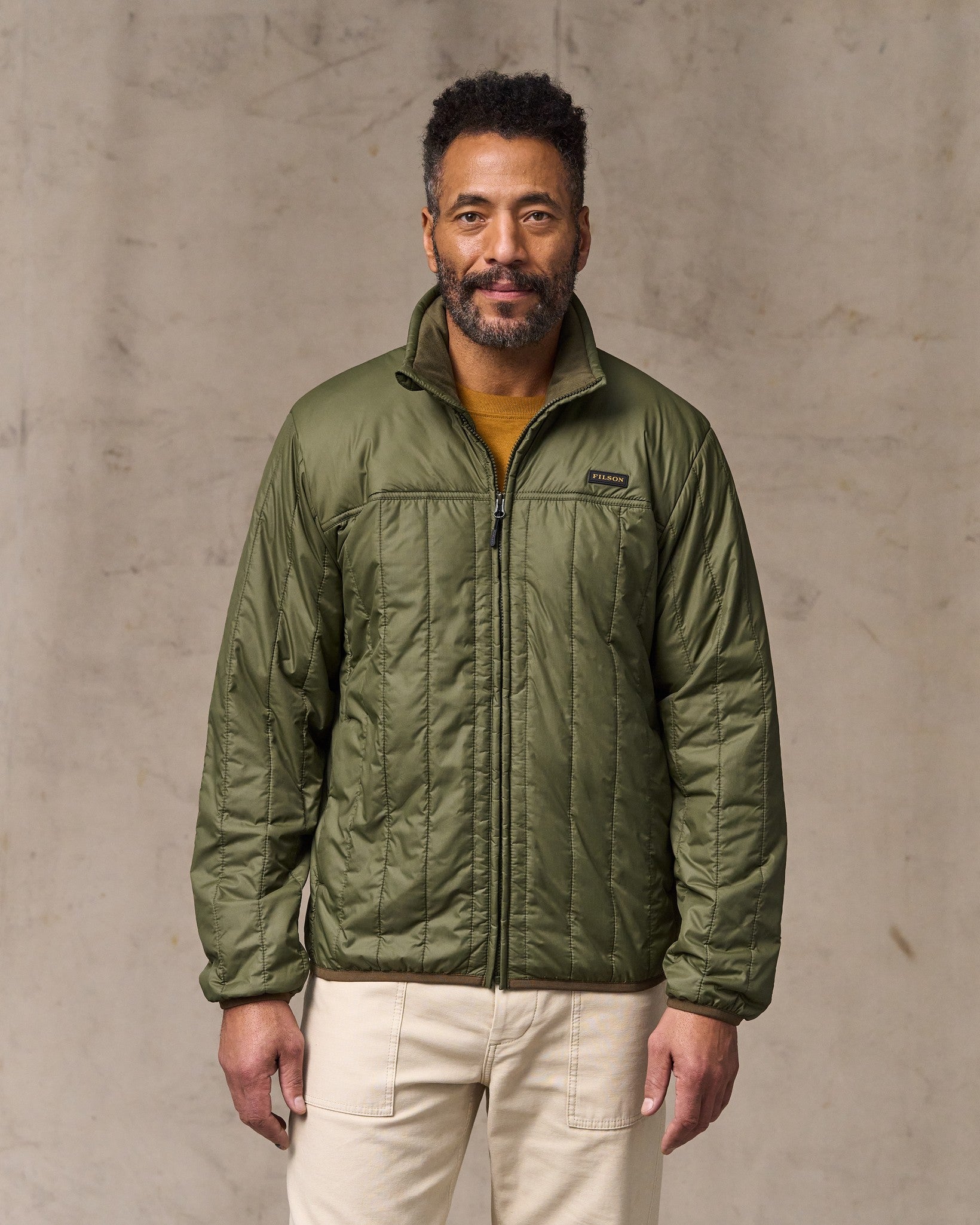 image of a model wearing Filson's Ultralight Jacket - Dark Olive Drab